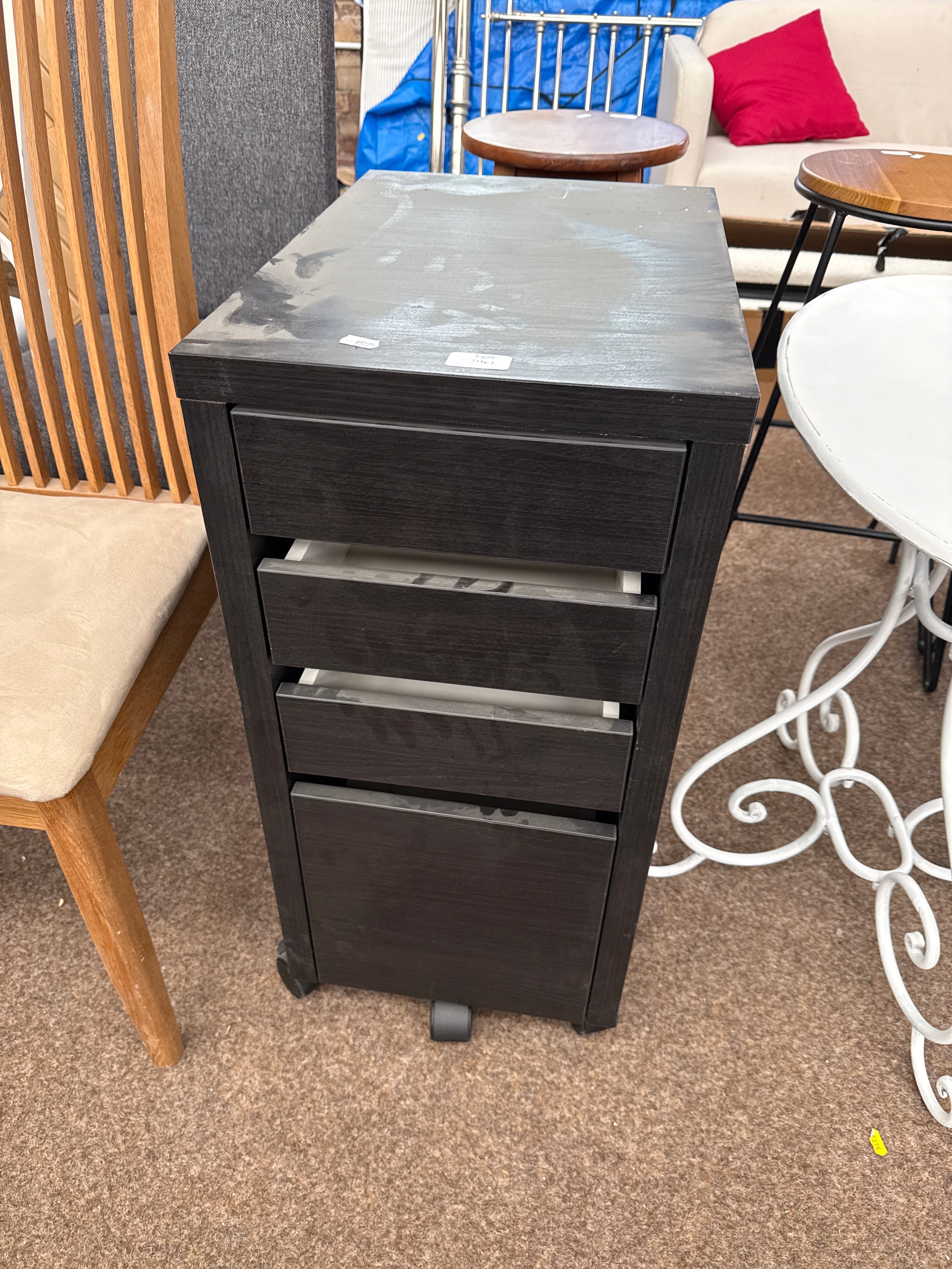 A small black 4 drawer chest on casters
