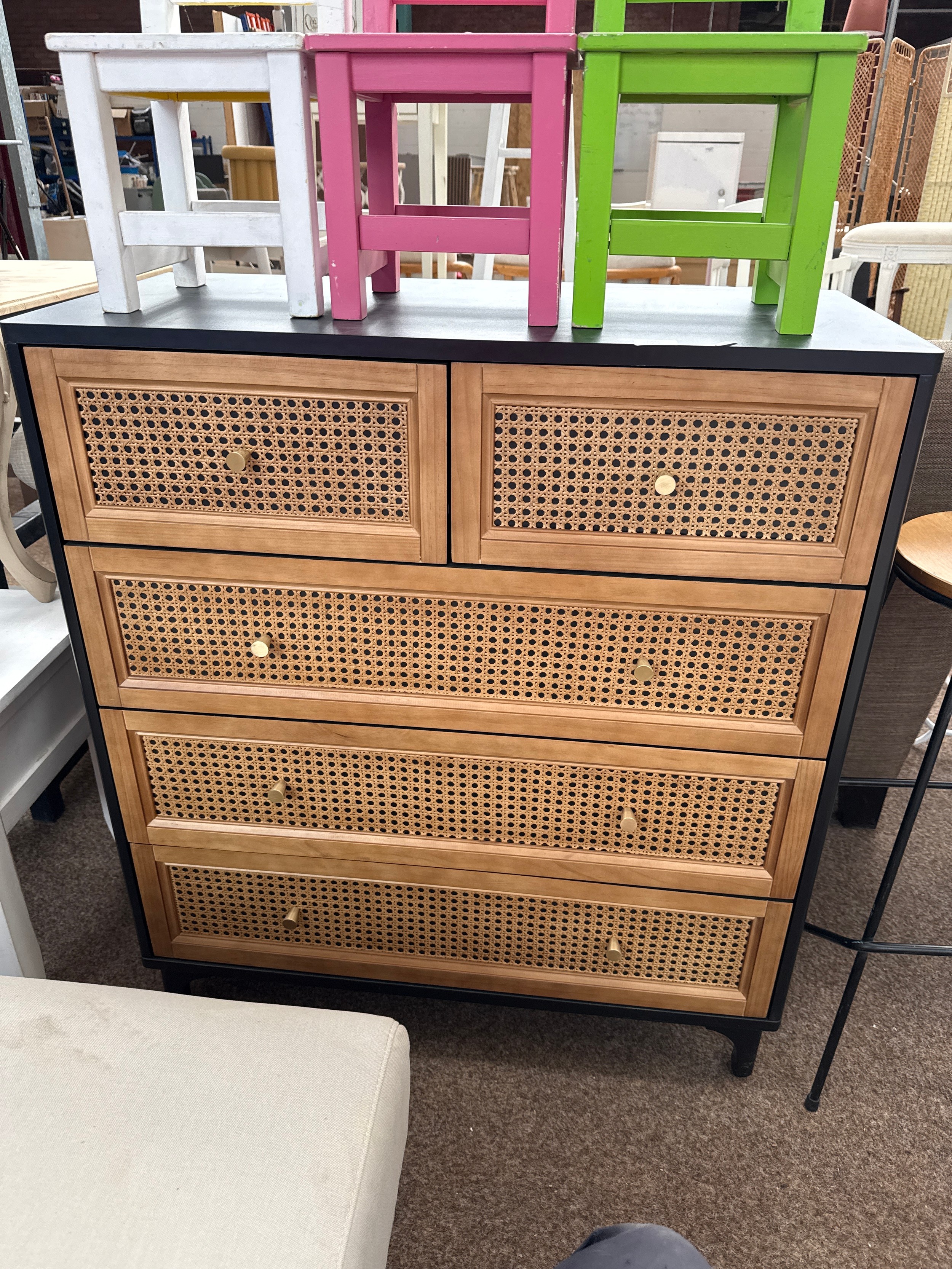 A modern 2 over 3 drawer chest with rattan panels, as new, never used