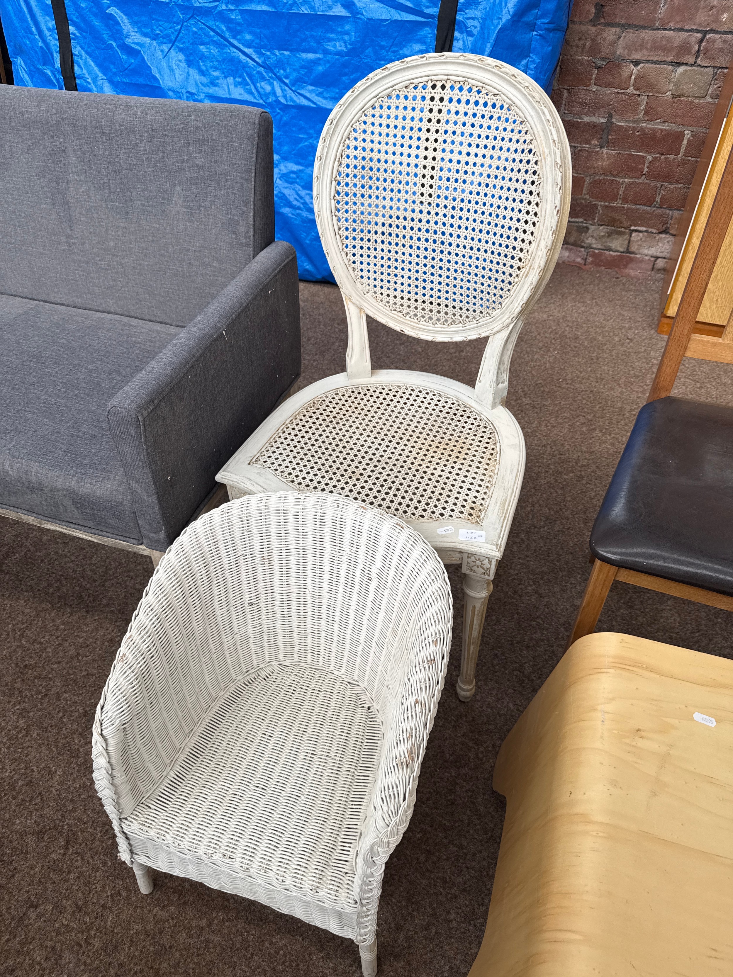 A vintage rattan panelled chair and a small painted basket chair, both as new