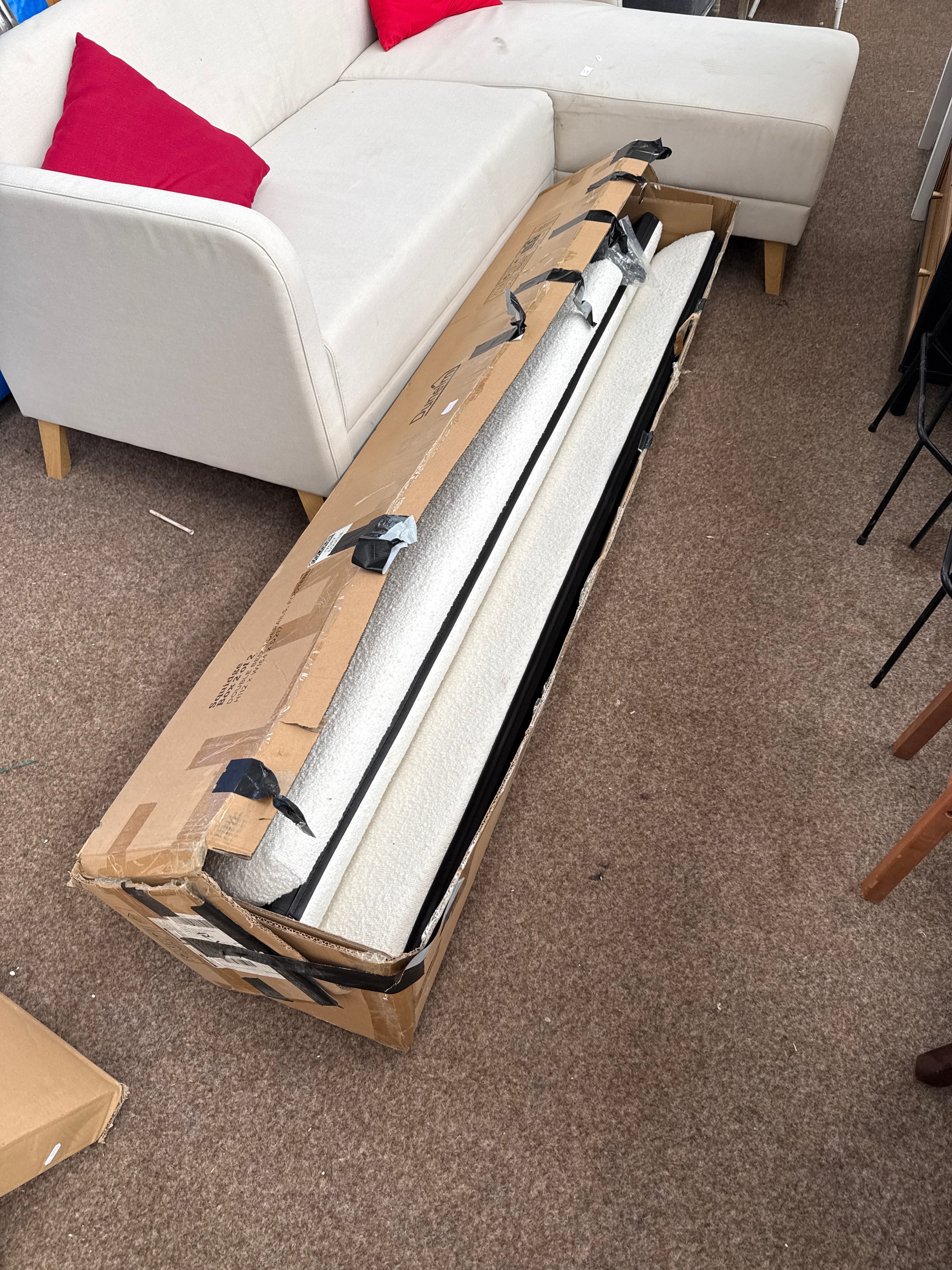 A boxed double bed frame with upholstered panels