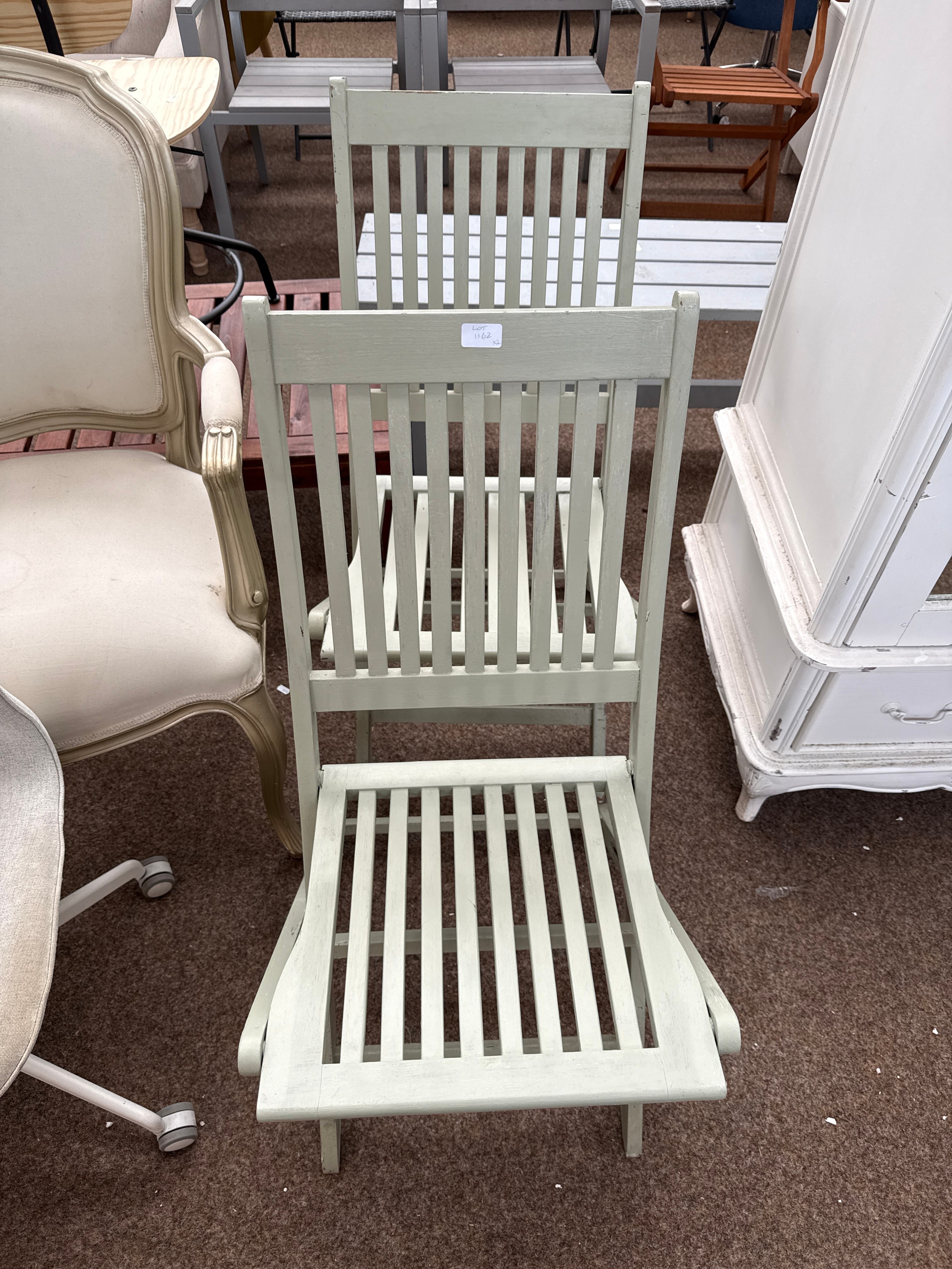 A pair of painted wooden folding garden chairs