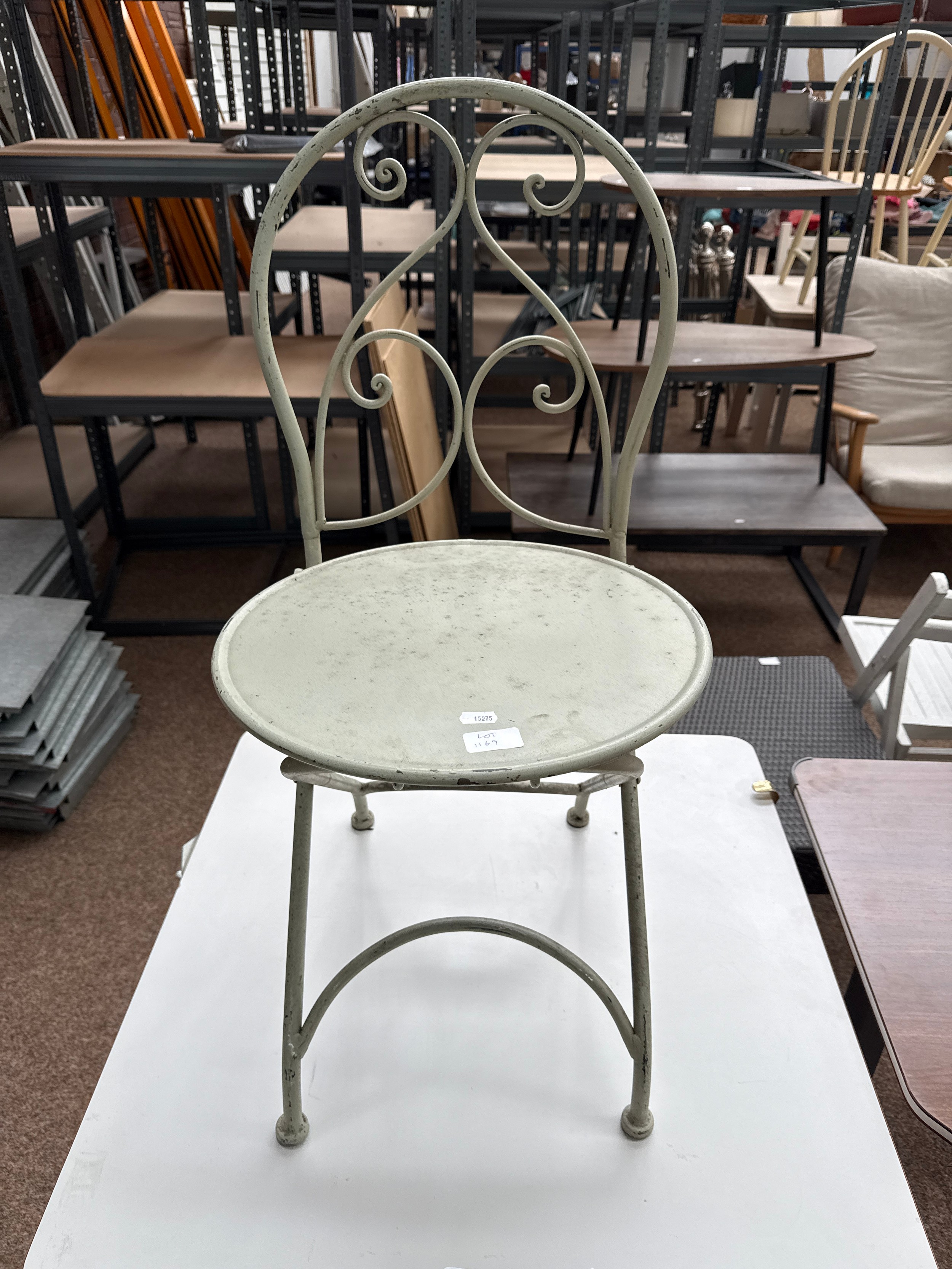 A small vintage decorative metal folding garden chair