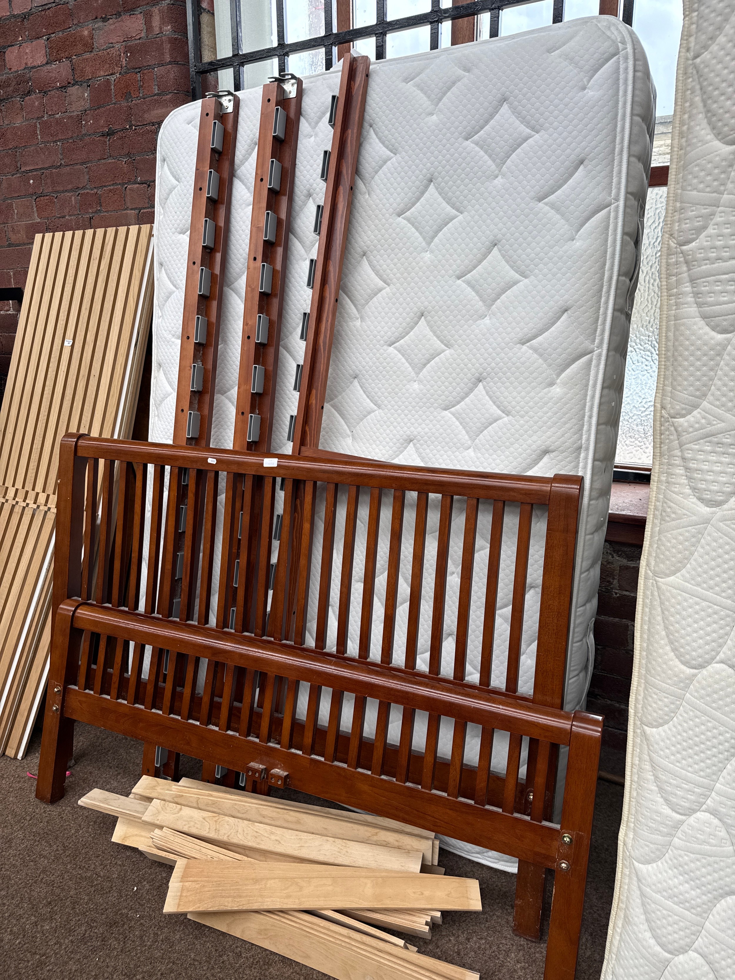 A vintage hardwood double bed with mattress