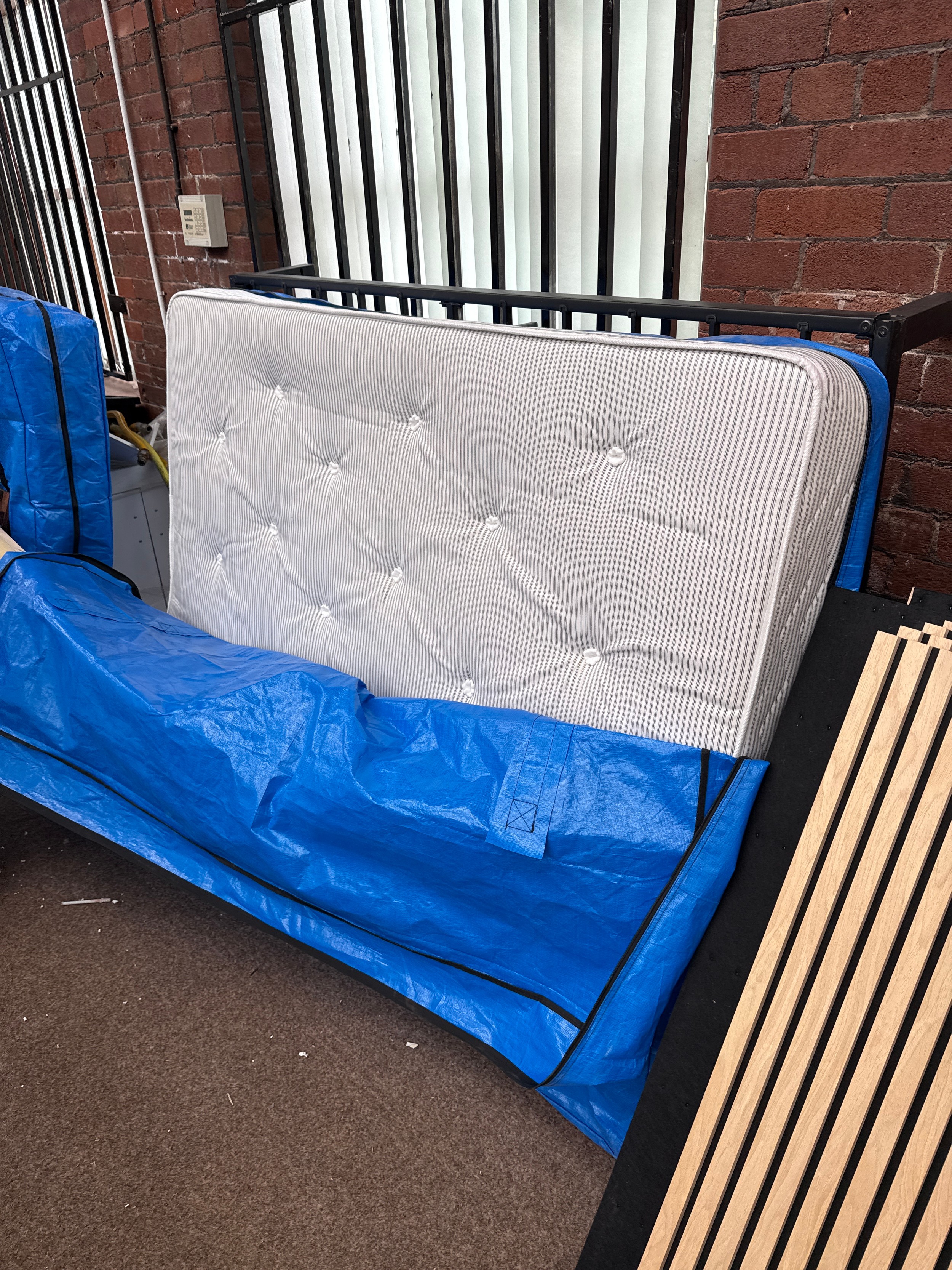 A double bed mattress in protective bag