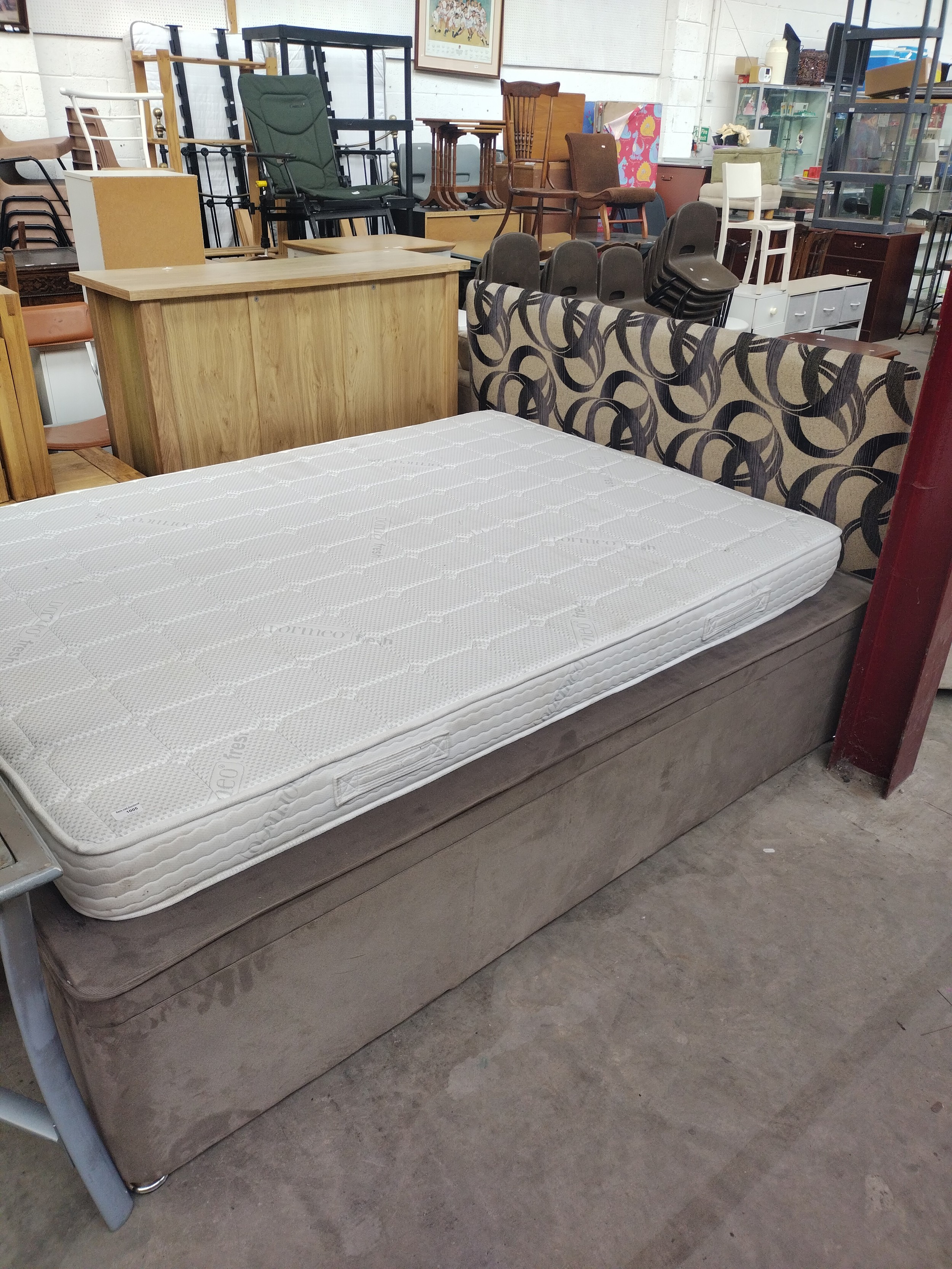 A double divan bed base with substitute mattress