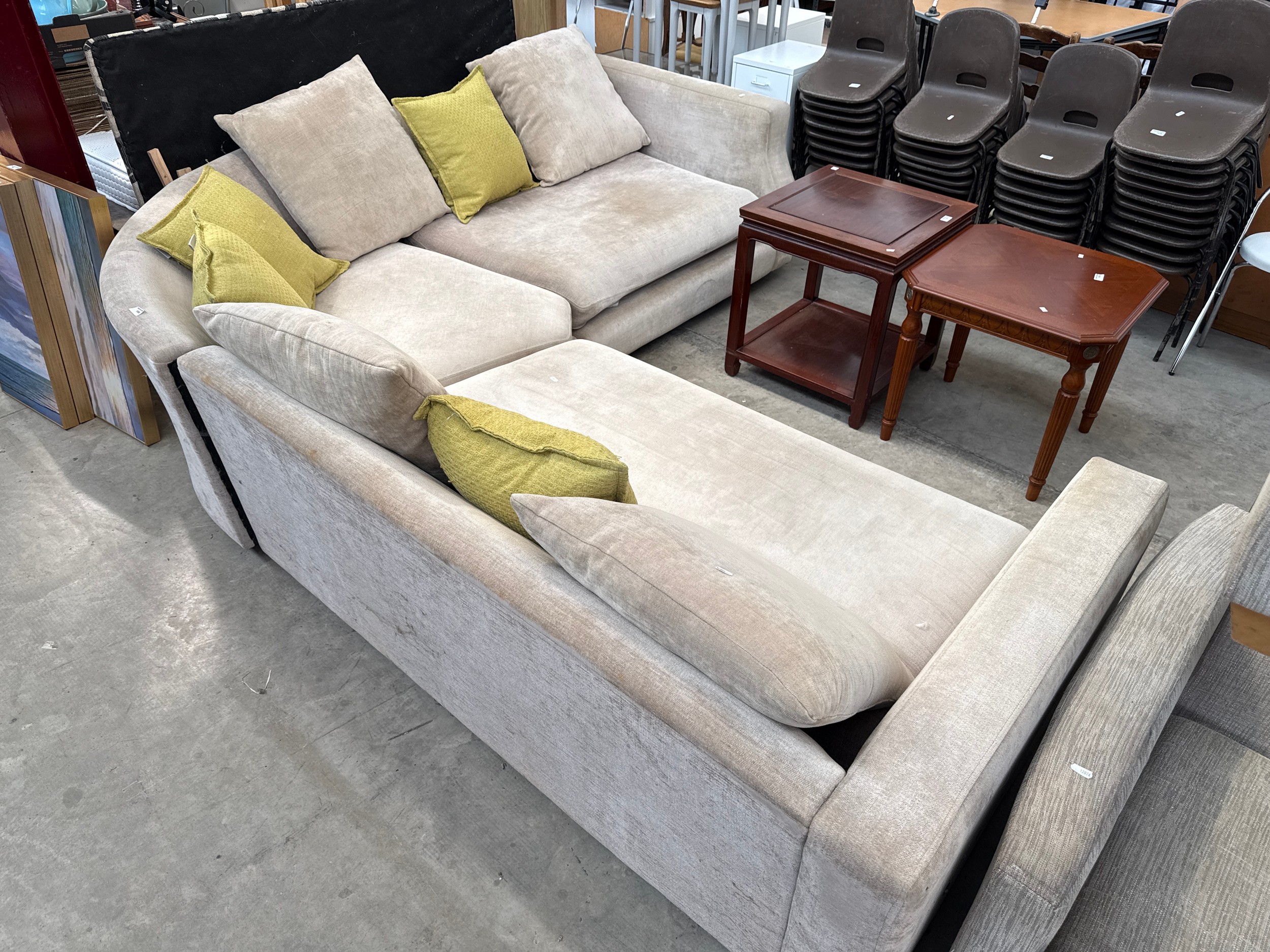 A large upholstered corner settee suite with cushions