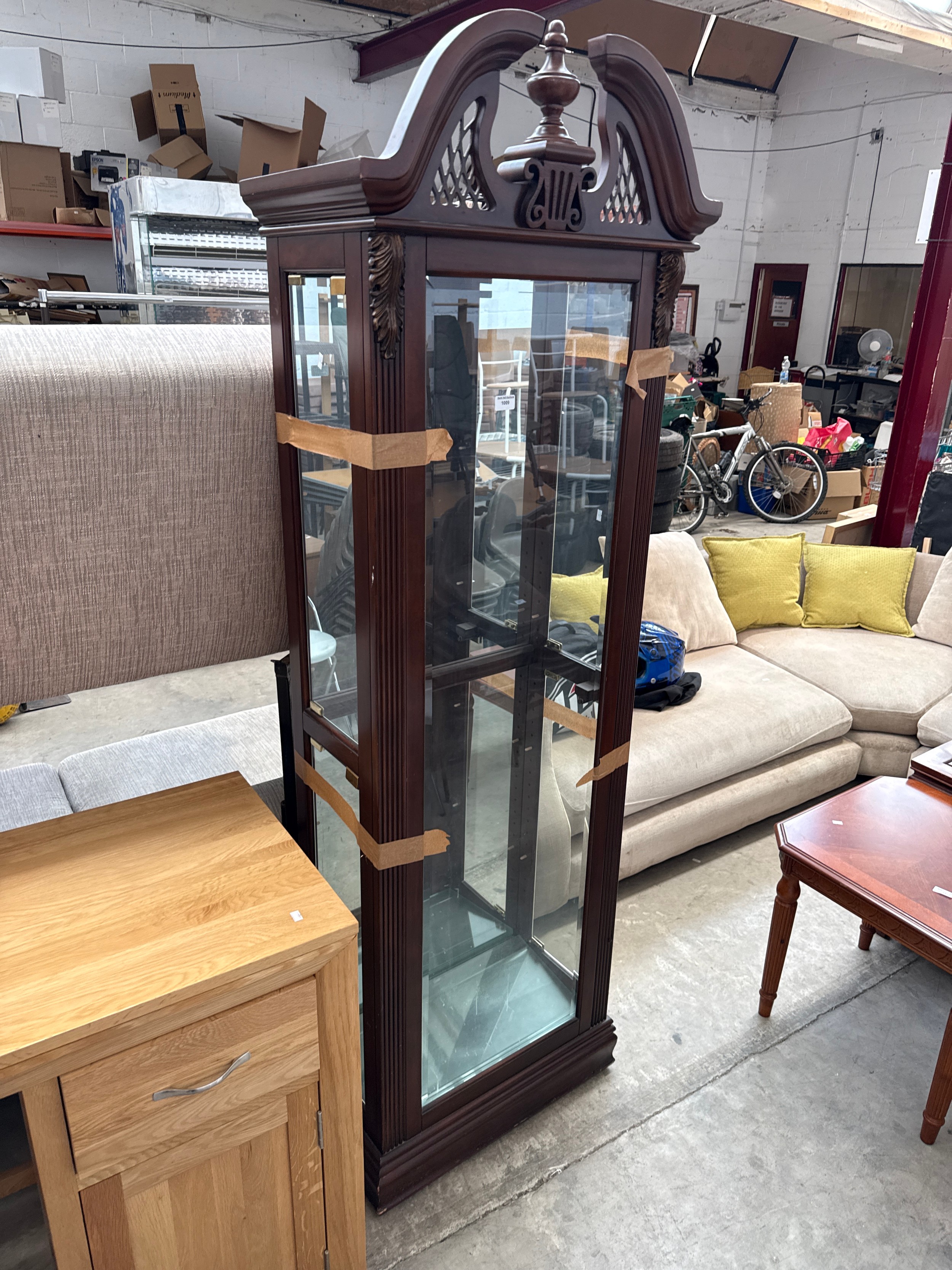 A vintage glazed mahogany display case