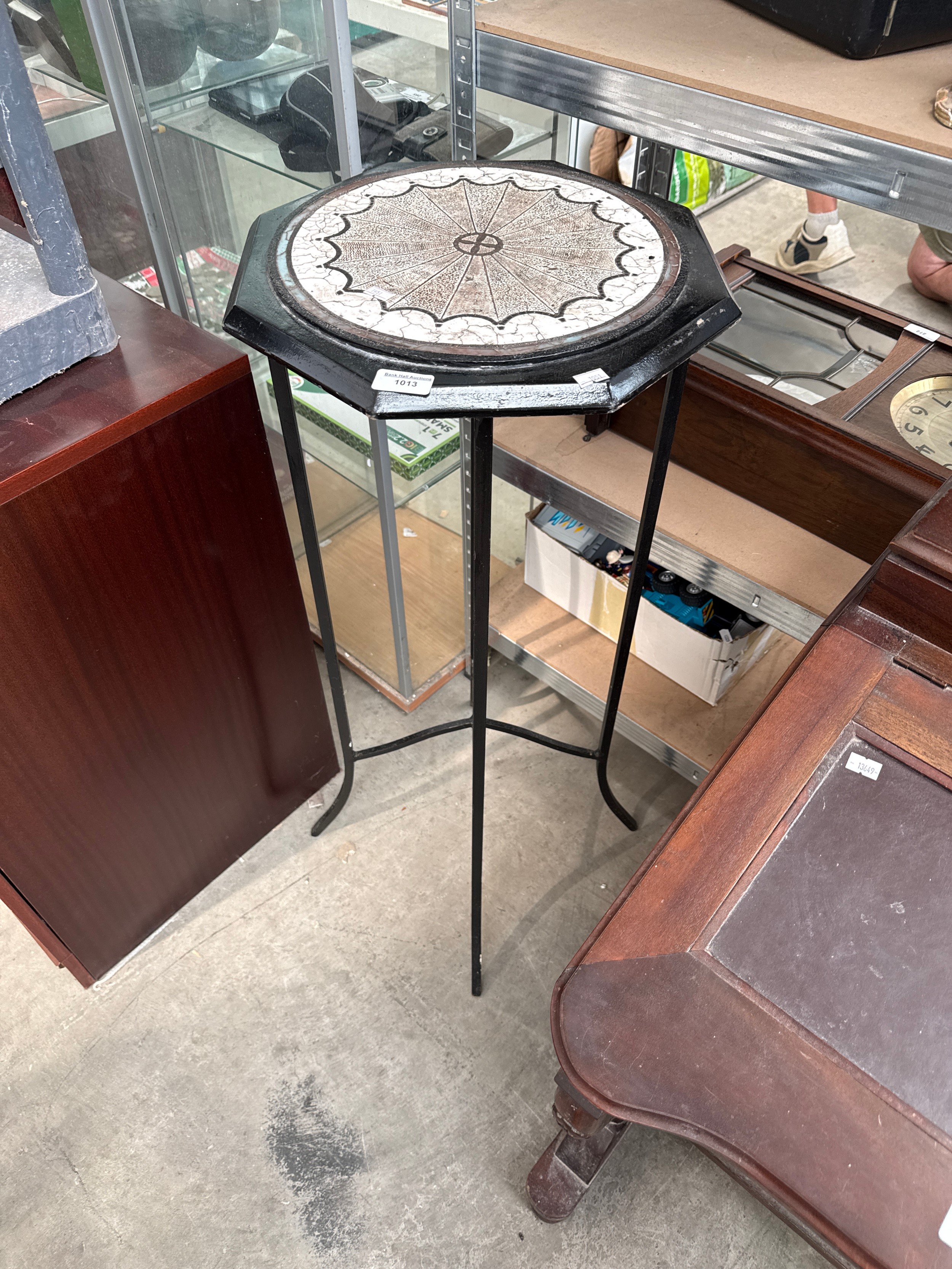 A decorative metal framed plant stand