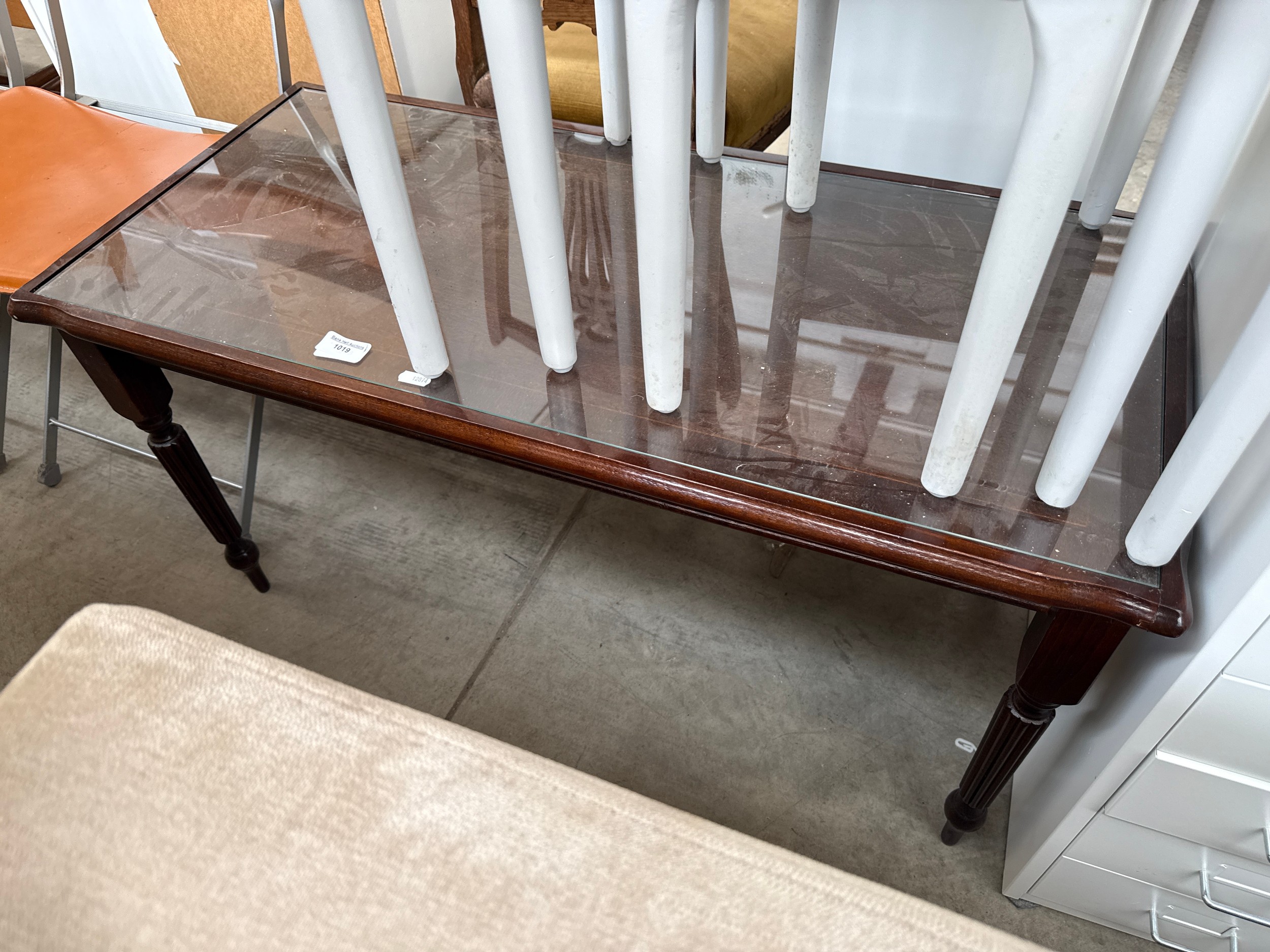 A vintage mahogany glass topped coffee table