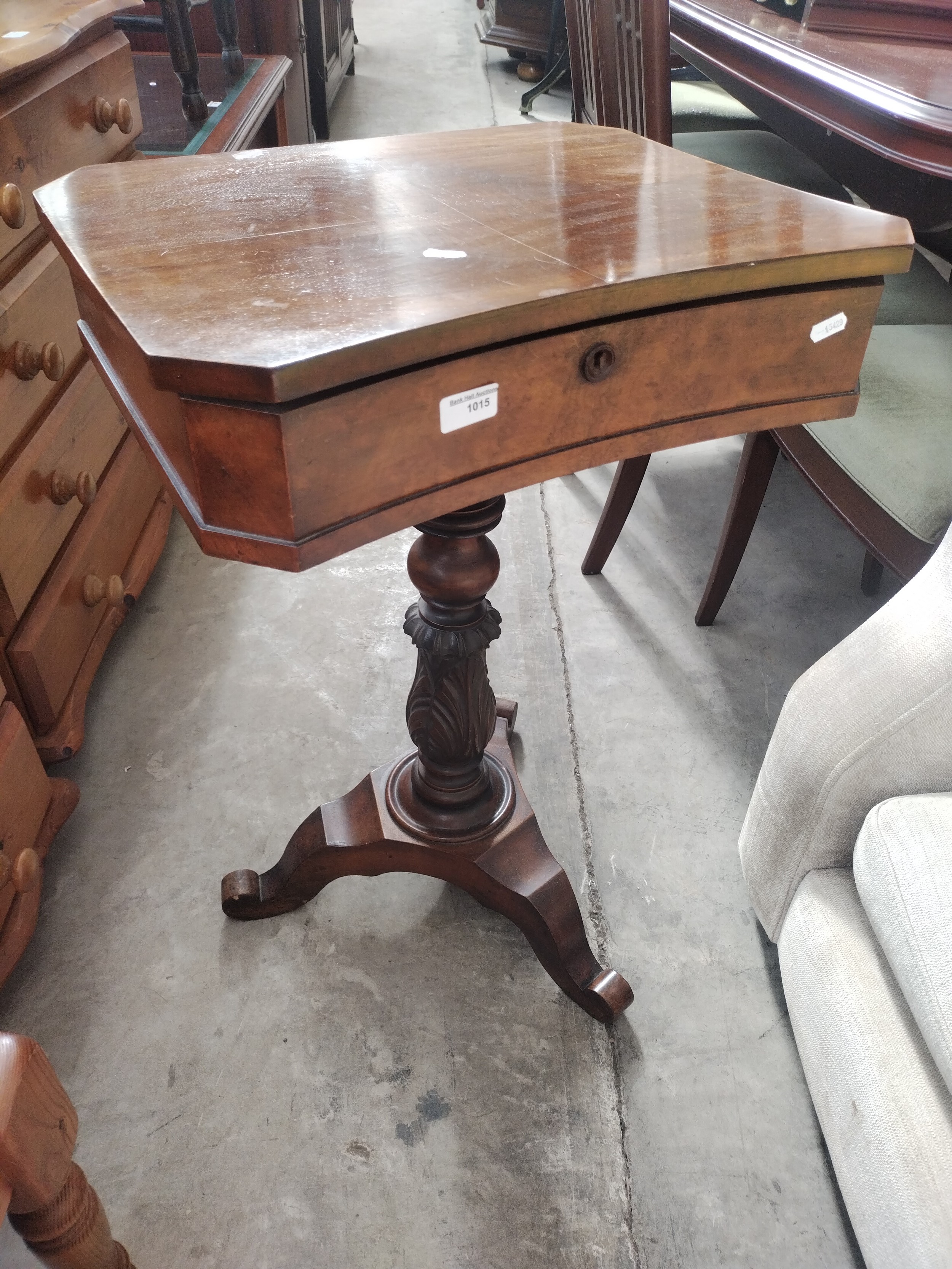 A vintage walnut lift top trinket box table on ornately carved tripod stand