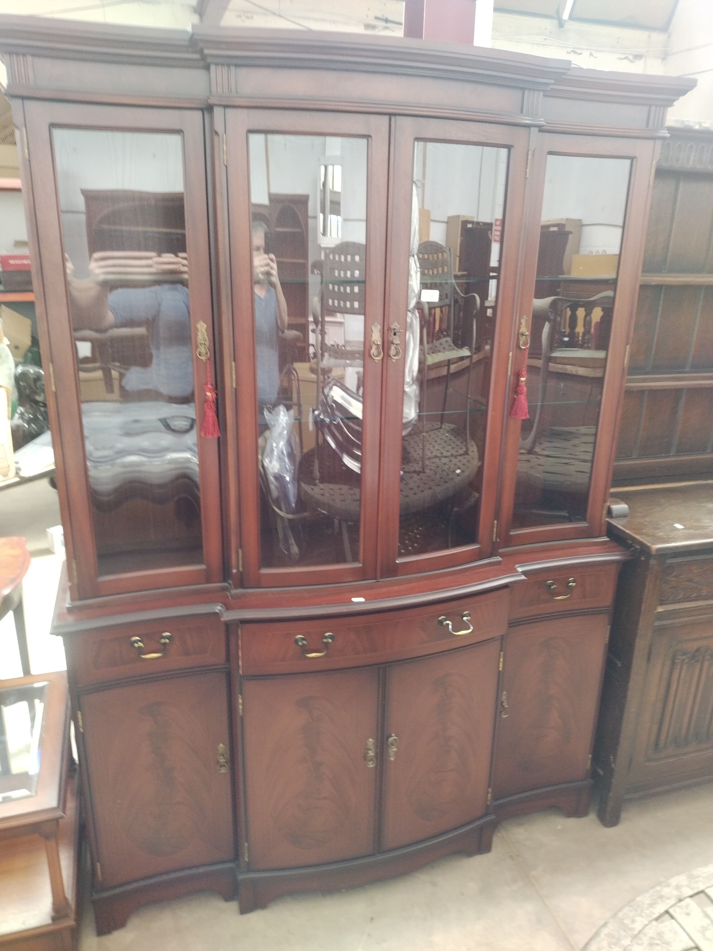 A large vintage glazed mahogany cabinet with 3 drawer base