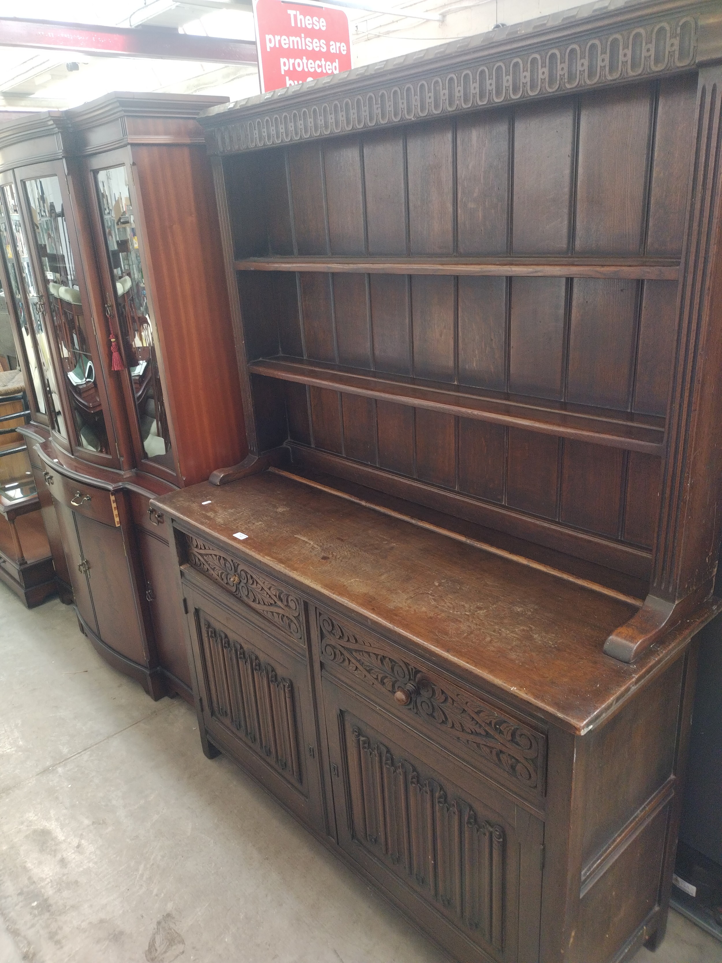 A large vintage carved oak 2 drawer dresser with linenfold doors