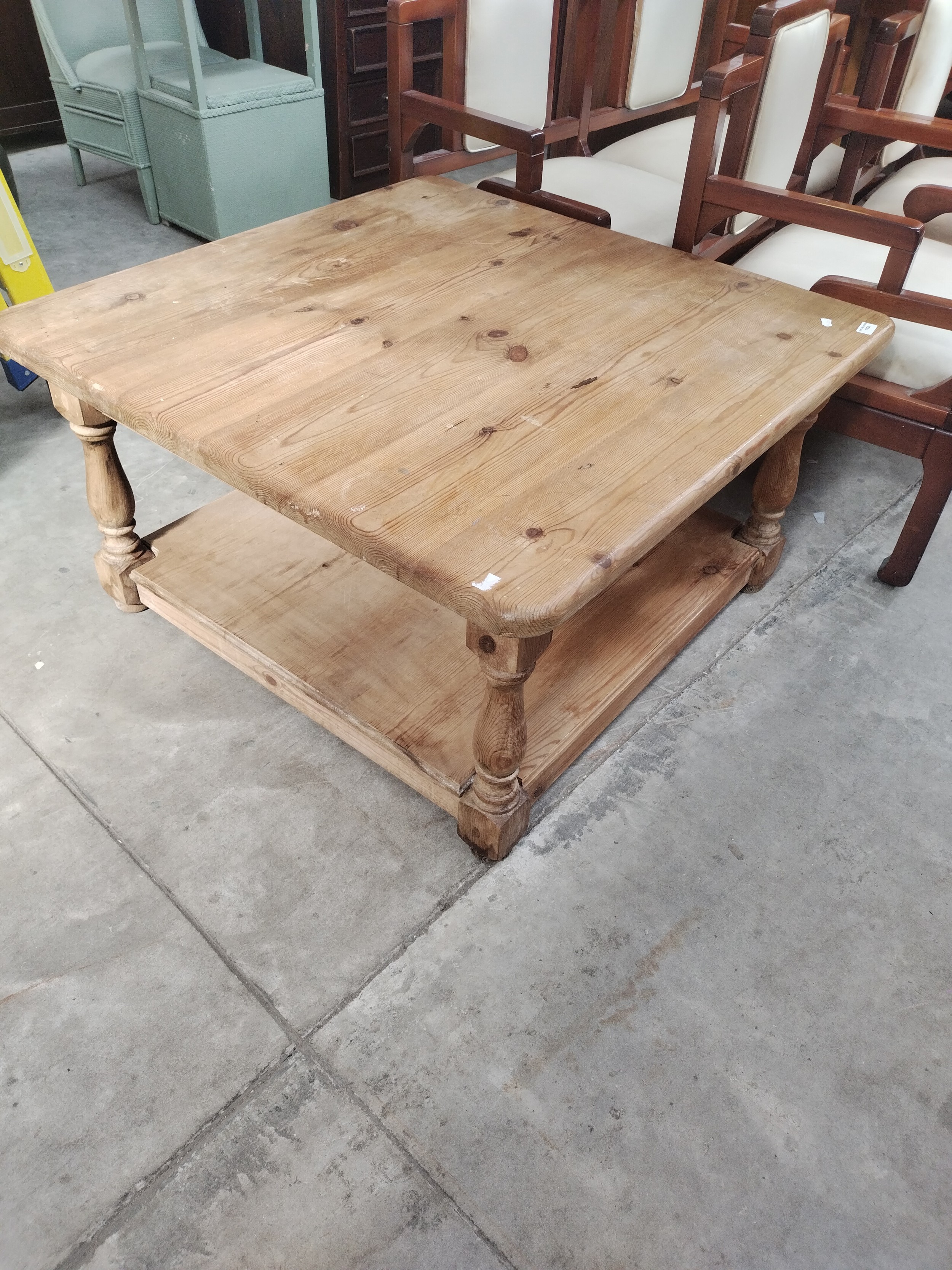 A large square vintage pine coffee table