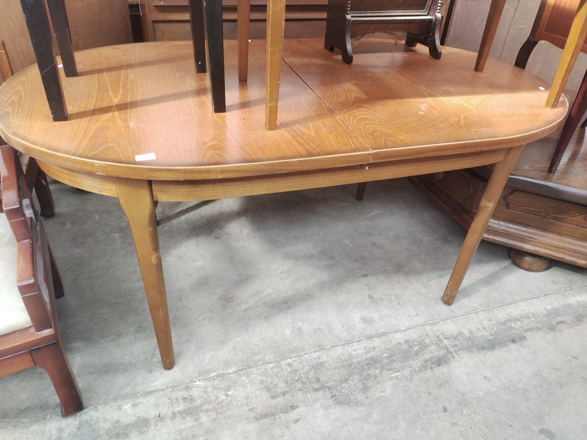 A large retro teak extending oval dining table
