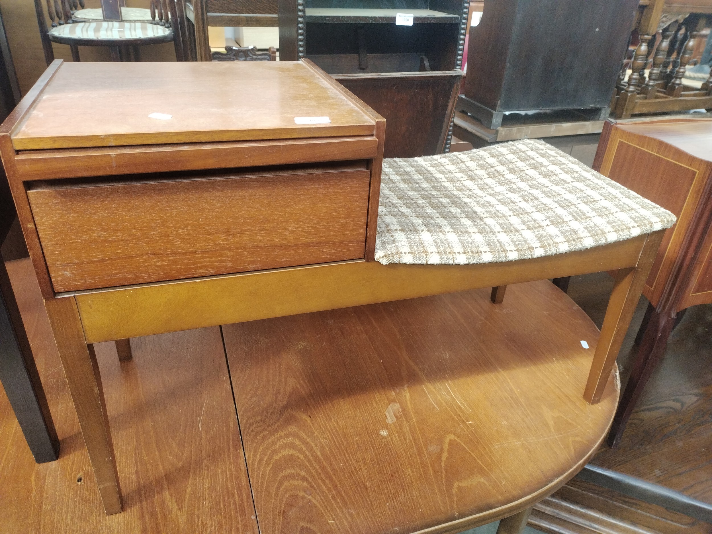 A retro teak hall seat with telephone table