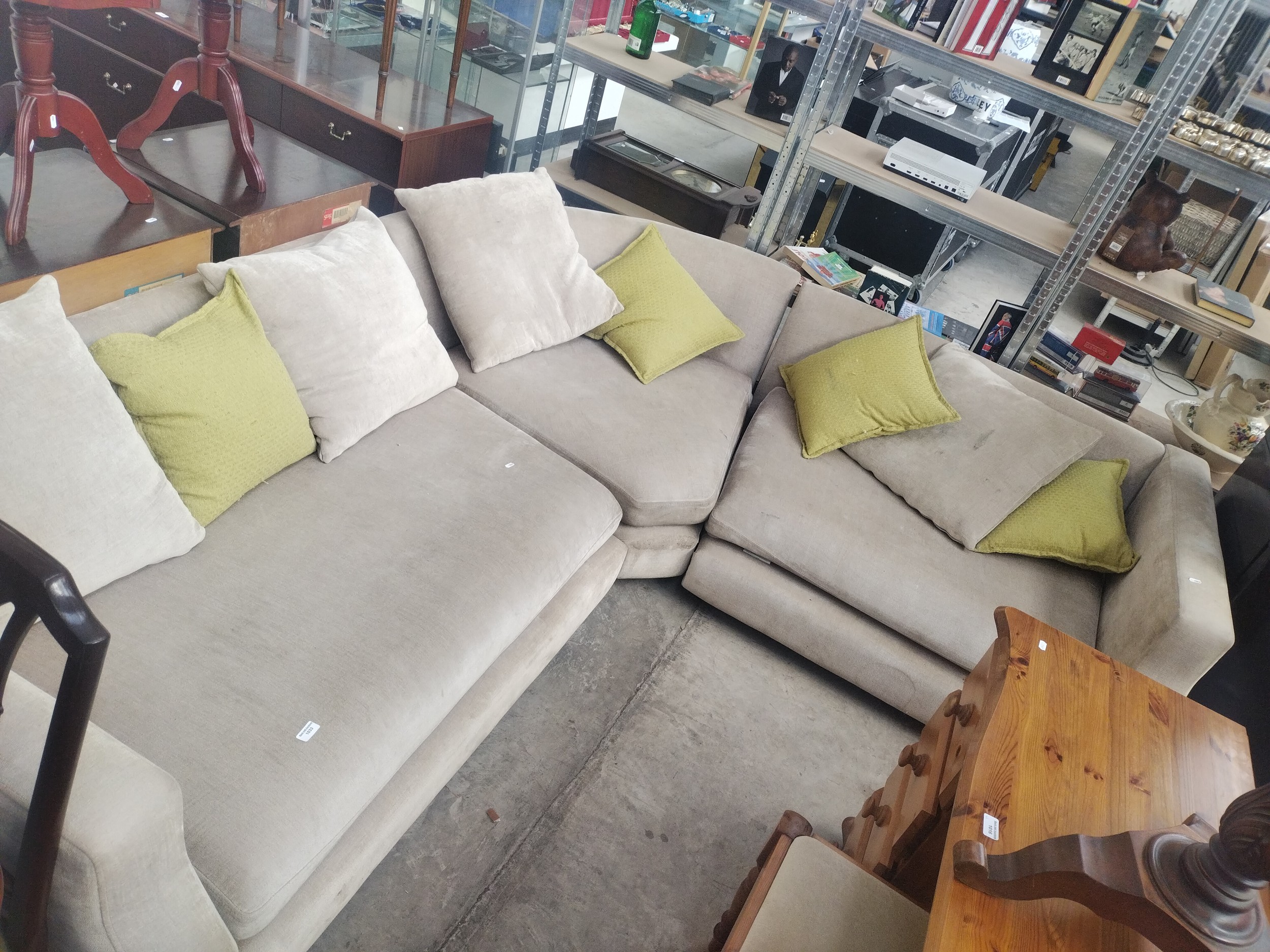 A large upholstered corner settee suite with cushions