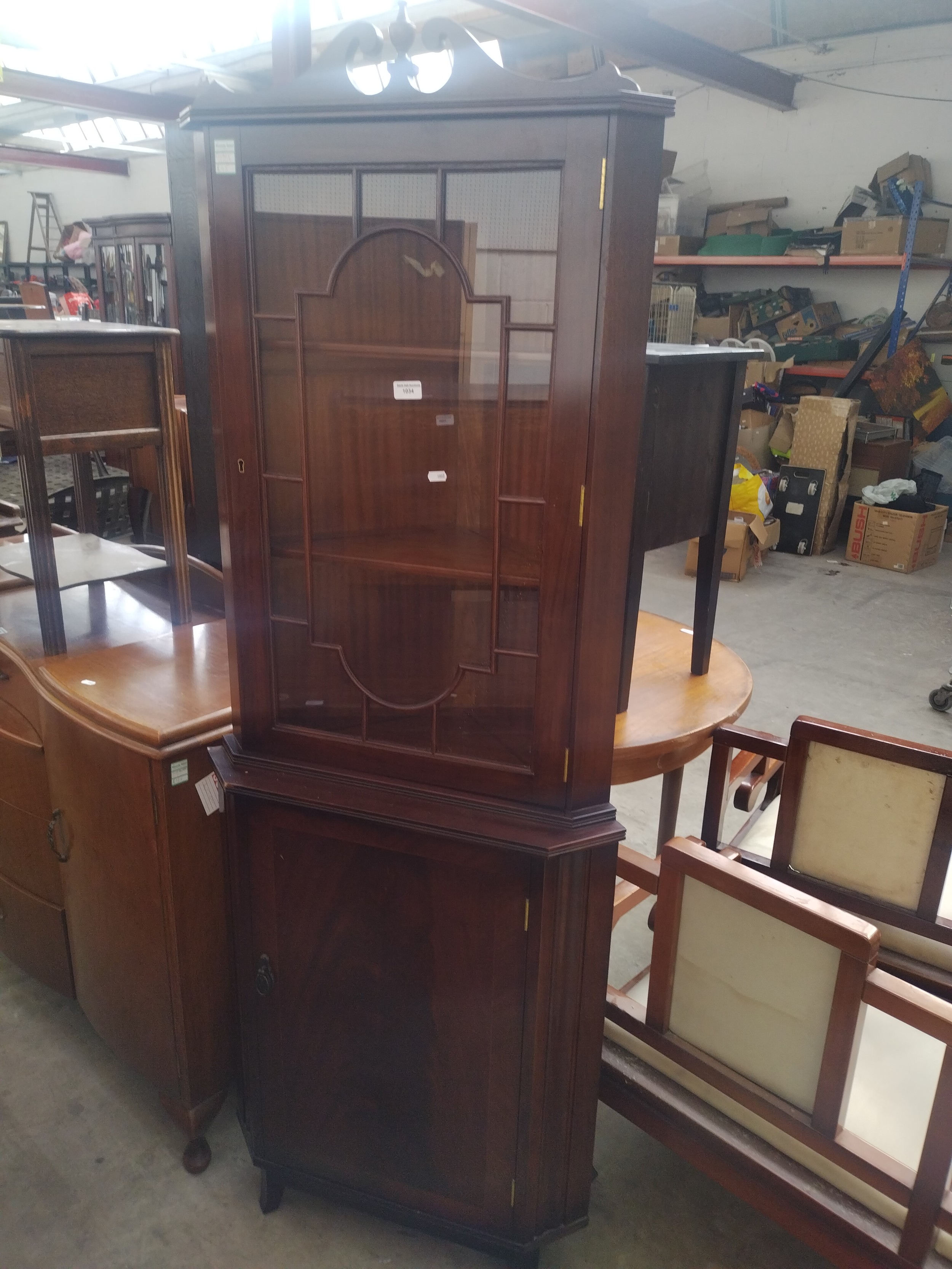 A vintage glazed mahogany corner cabinet