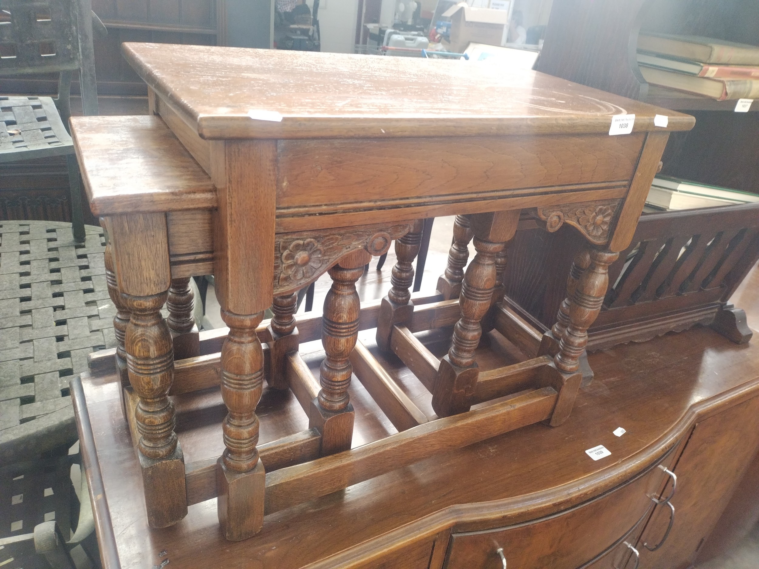 A vintage carved oak occasional table with 2 x nested tables