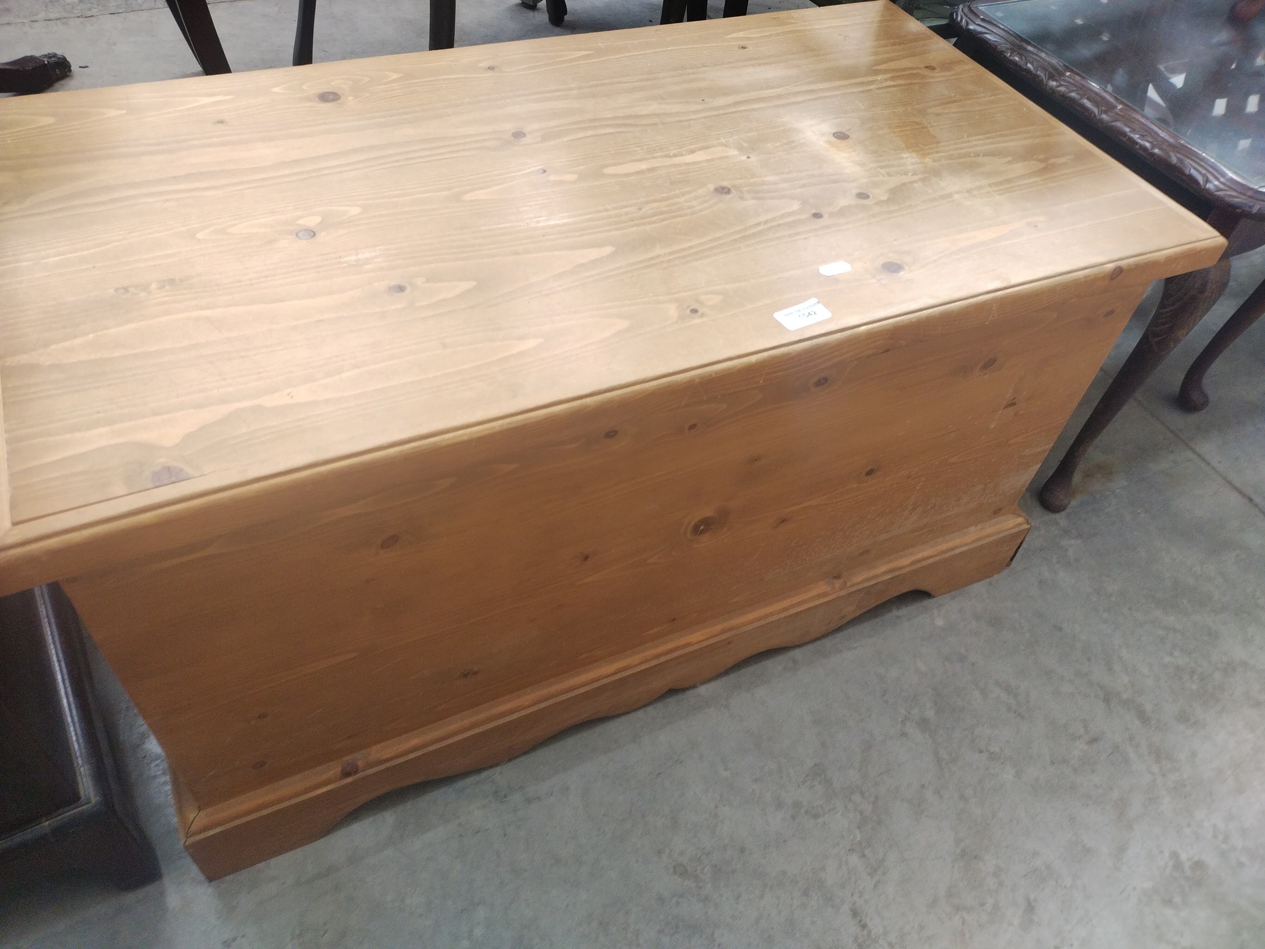 A lift top pine storage box