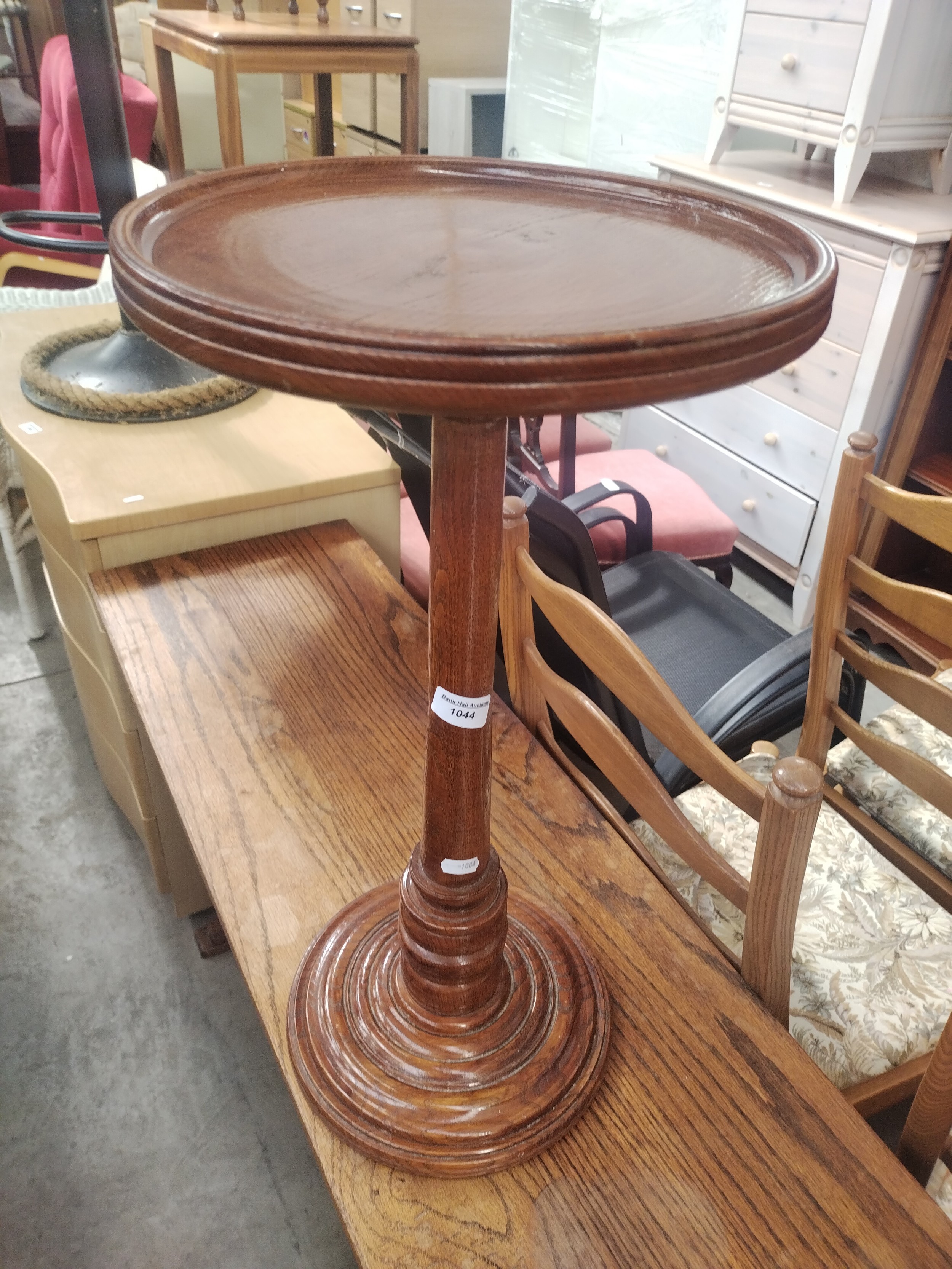 A vintage wooden pedestal plant stand