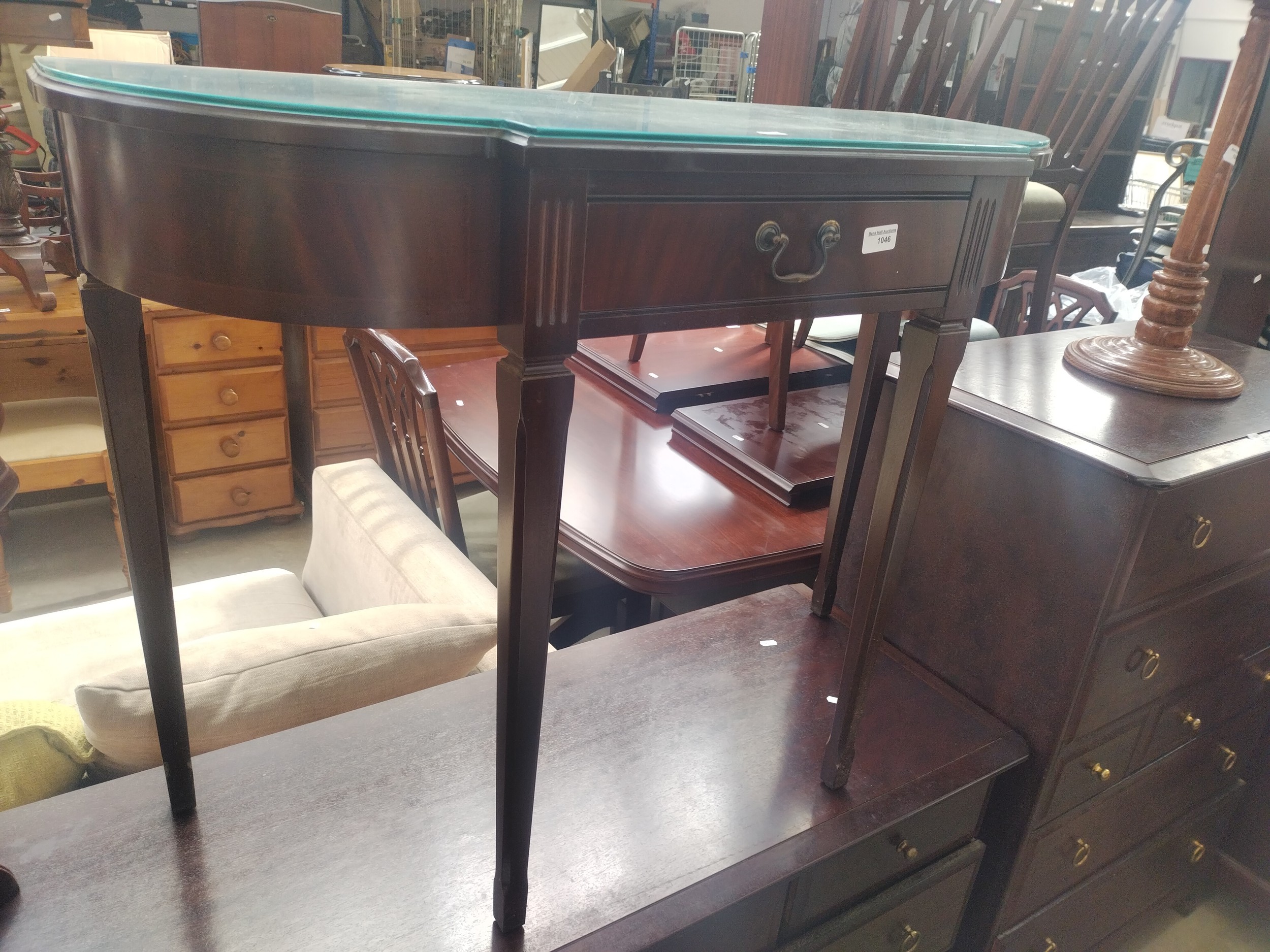 A vintage break front mahogany console table with drawer and glass top protector