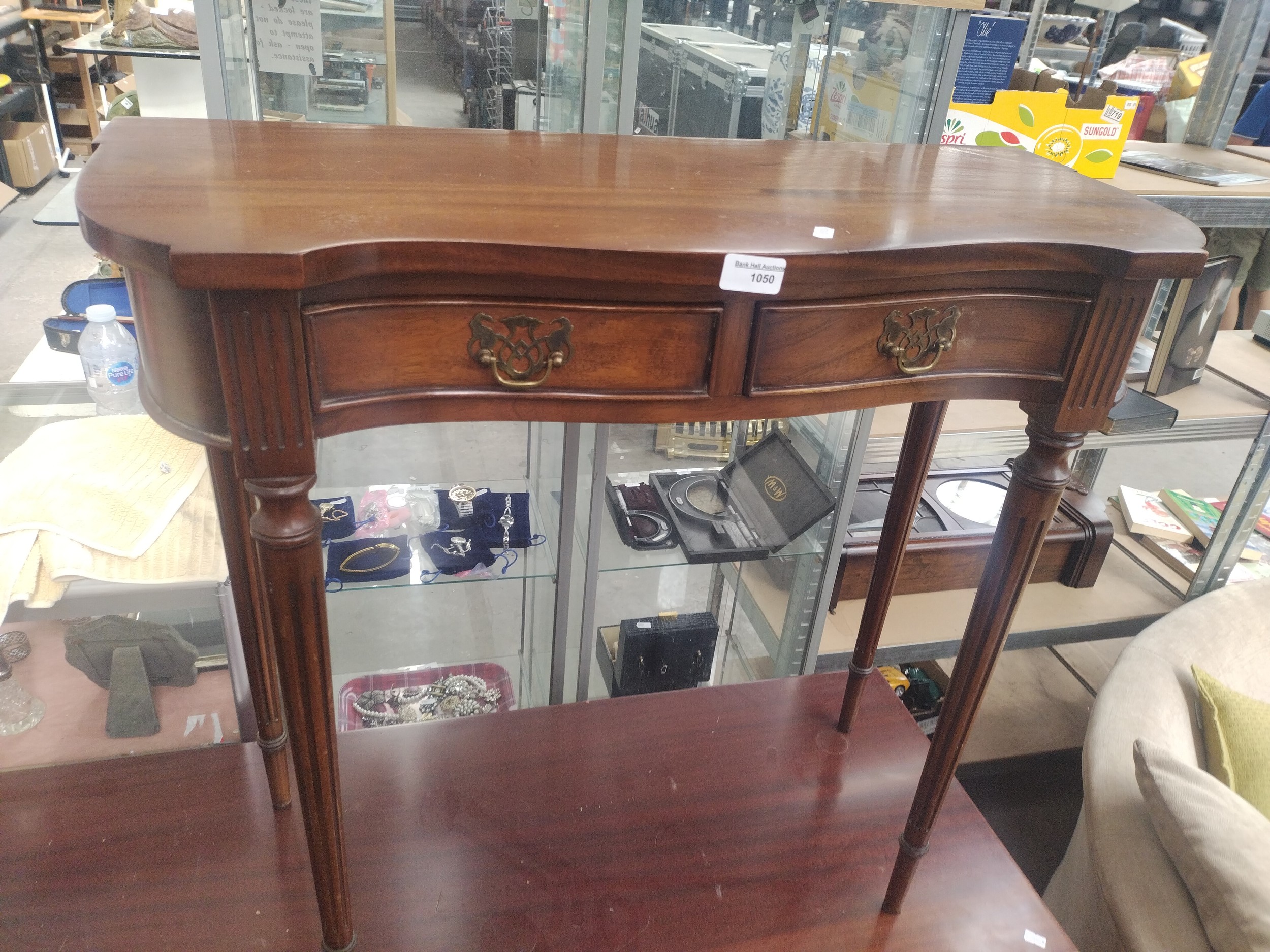 A vintage 2 drawer serpentine fronted console table on splined legs