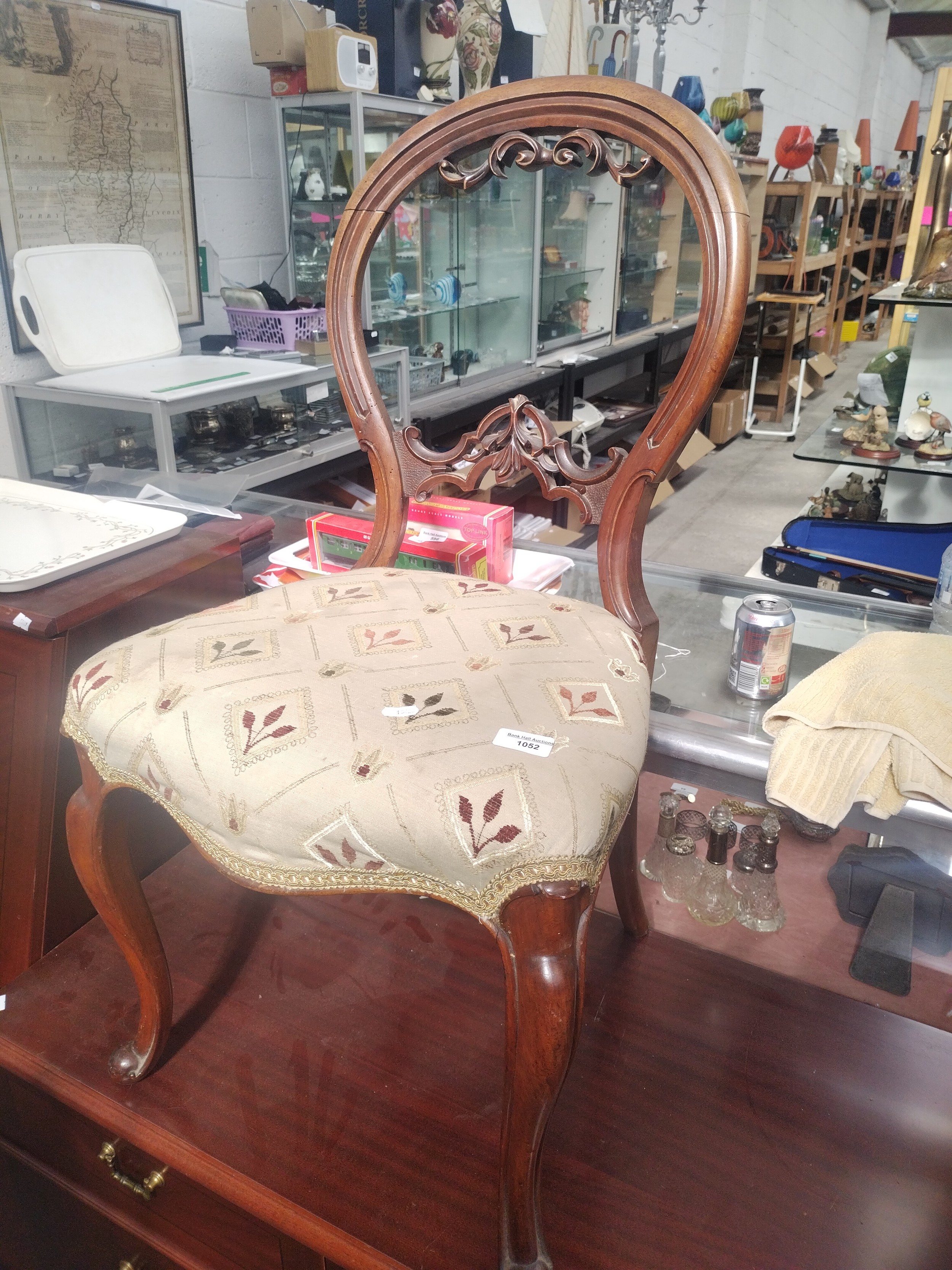 A vintage carved balloon back bedroom chair with upholstered seat