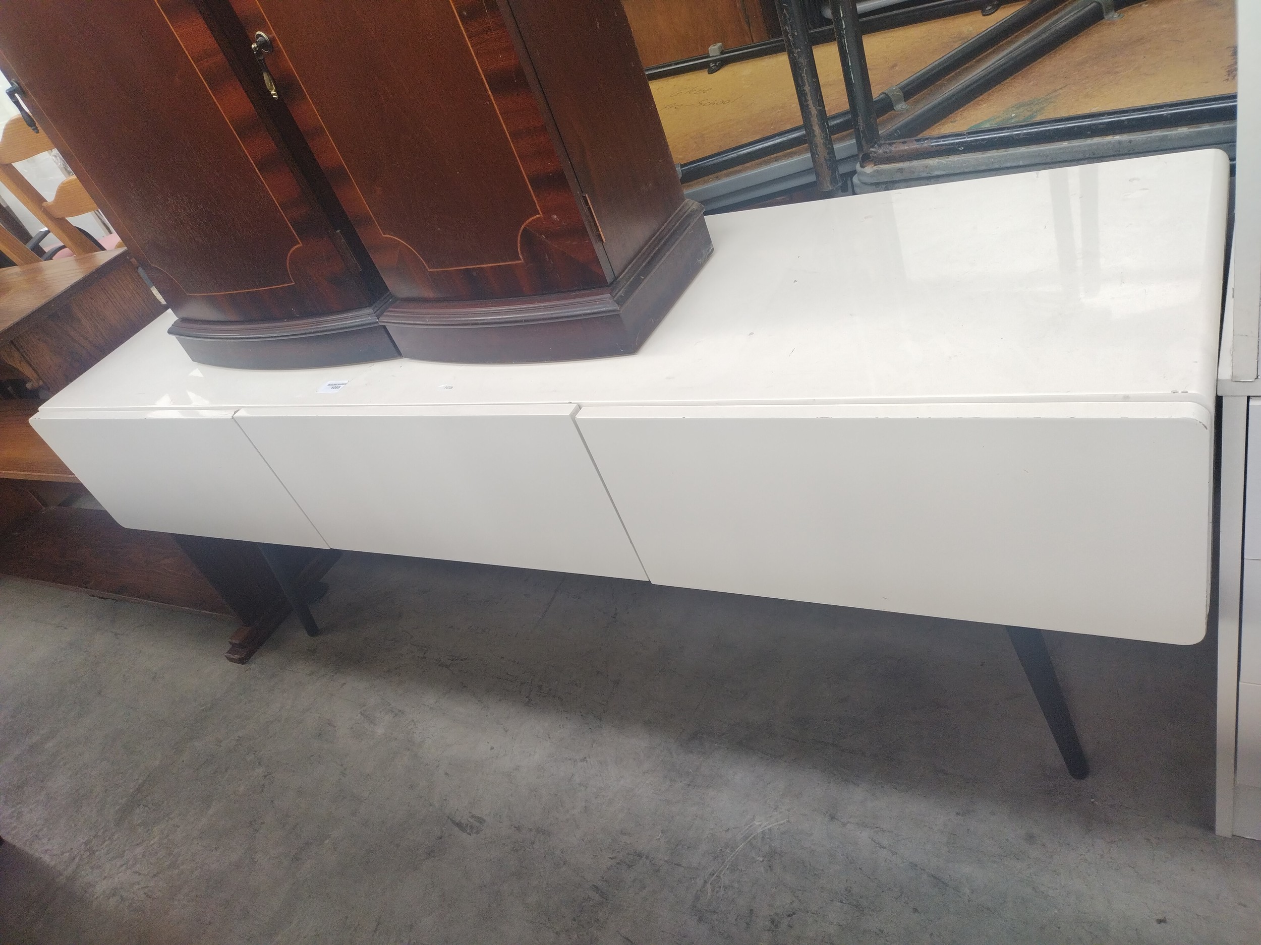 A low white gloss 3 drawer sideboard on tapered legs