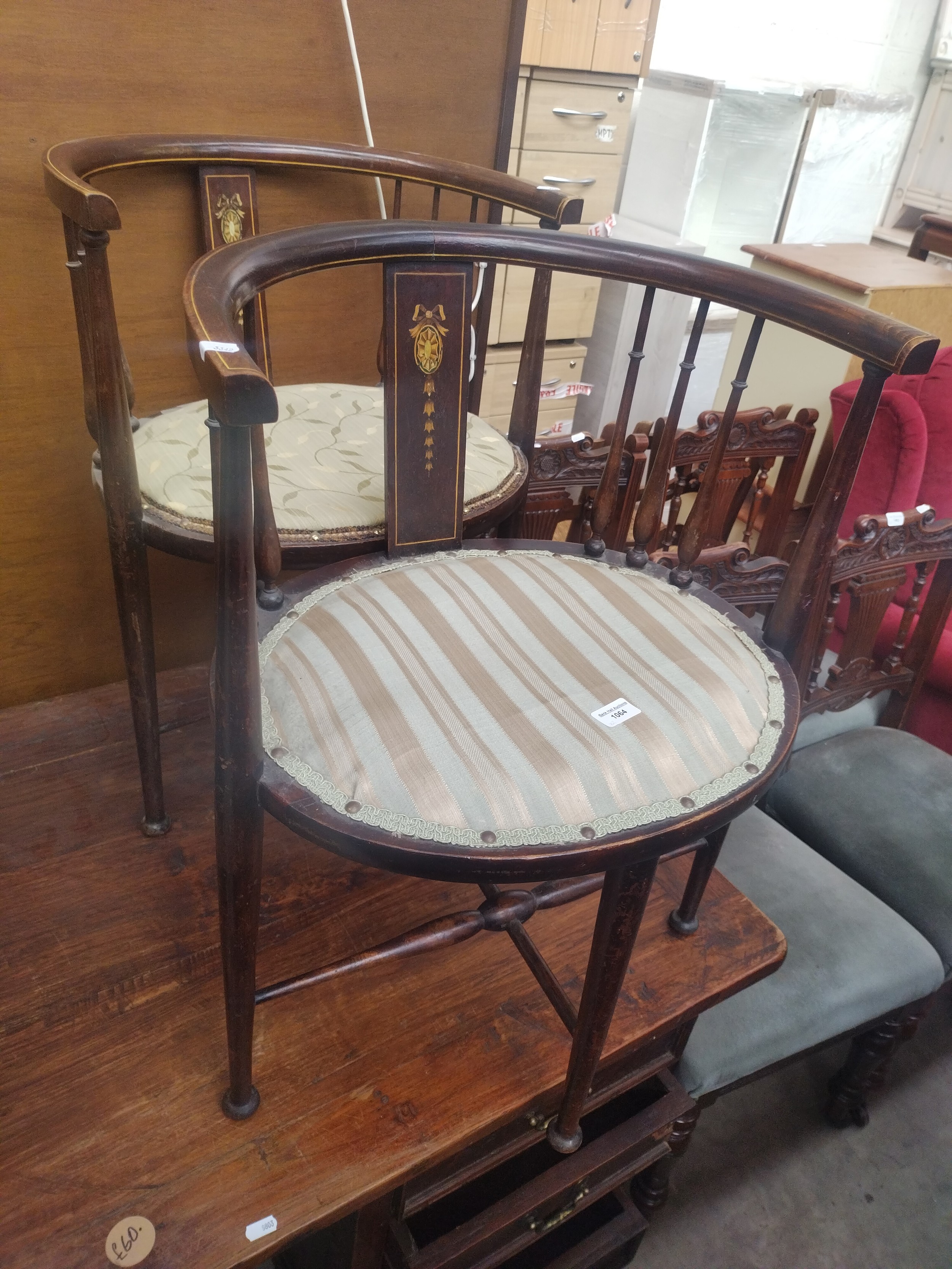 A pair of inlaid Edwardian spindle backed tub chairs with upholstered seats