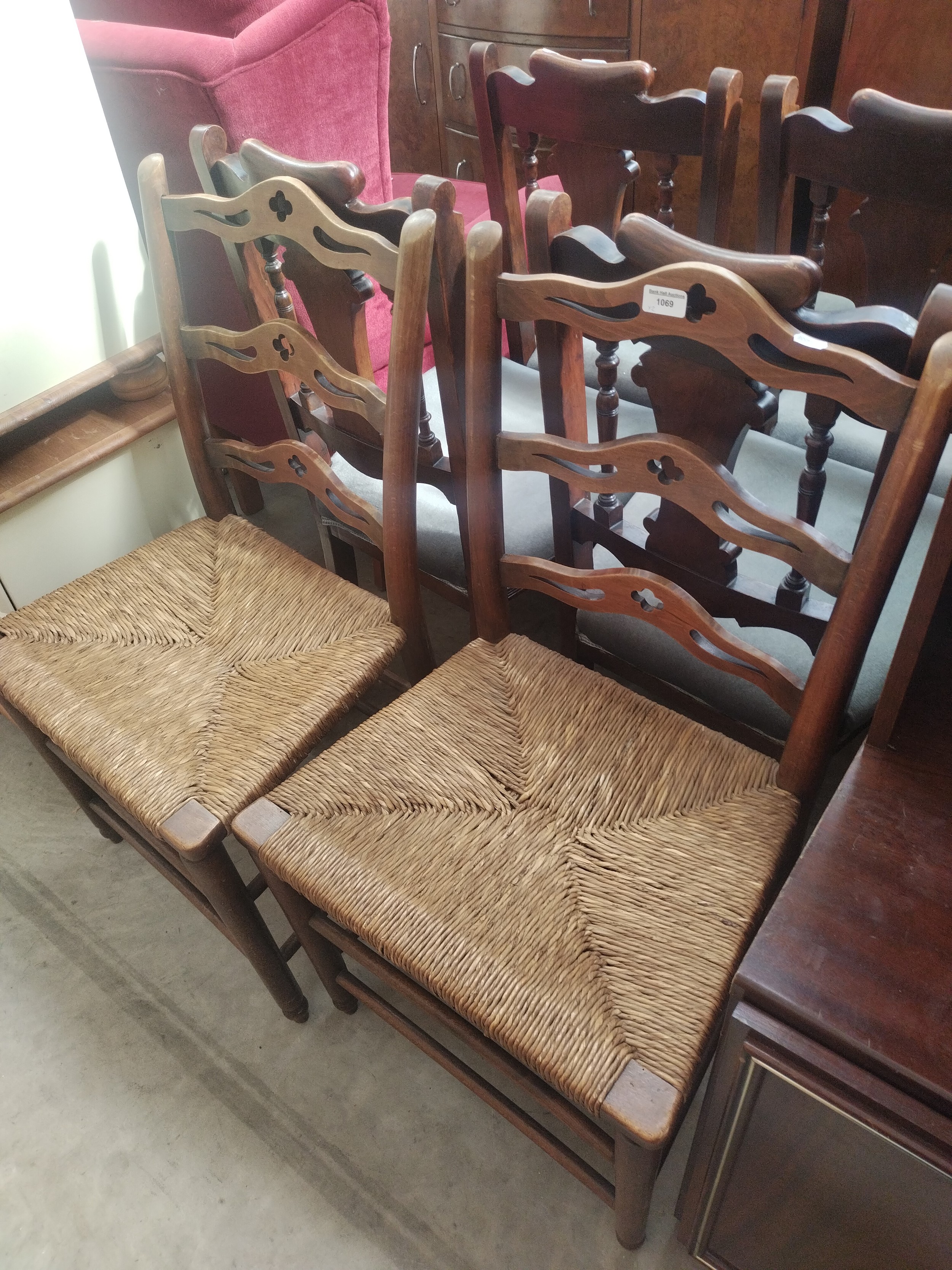 A pair of vintage rush seated ladder back chairs