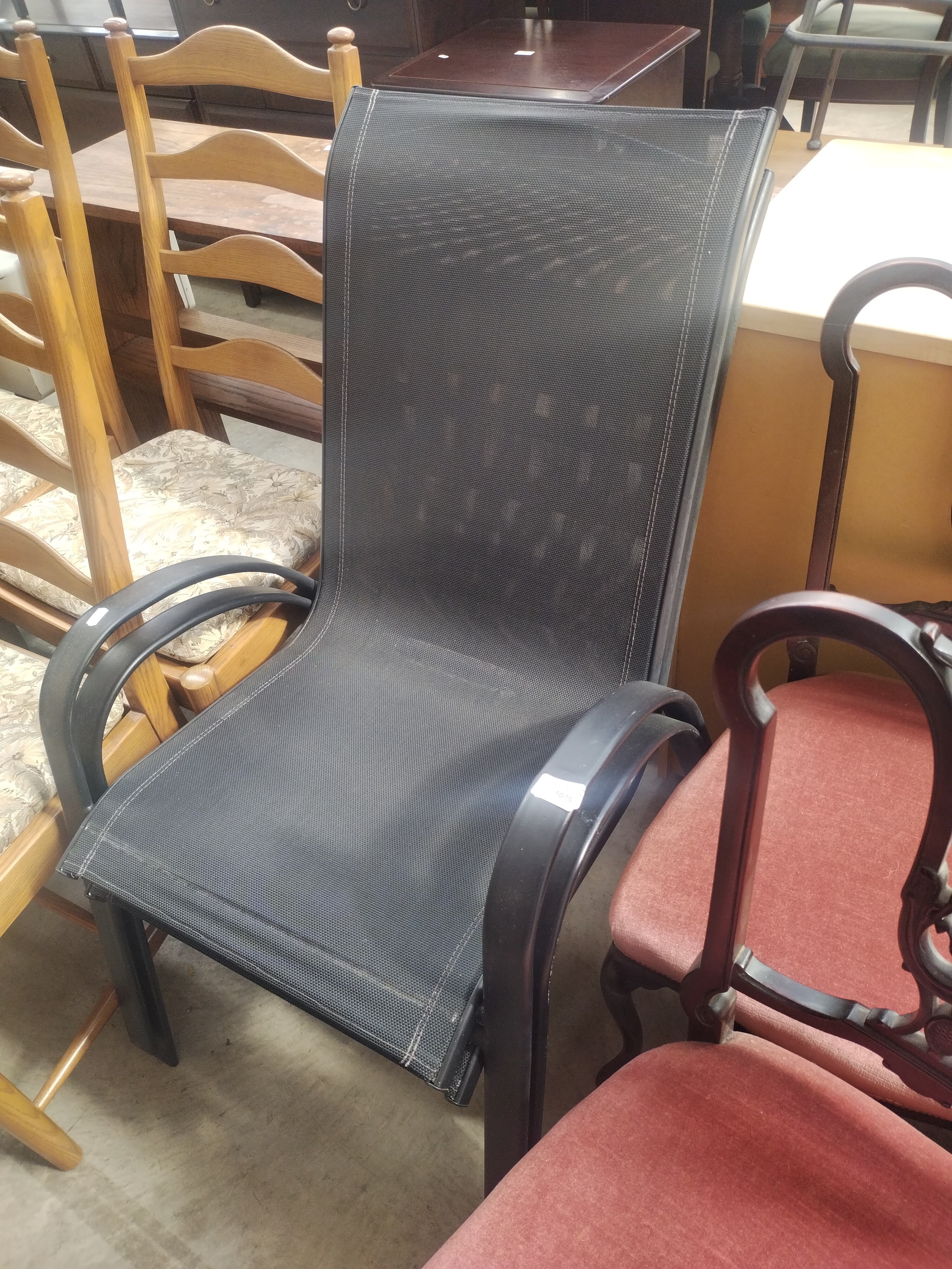 A pair of metal framed stacking patio chairs