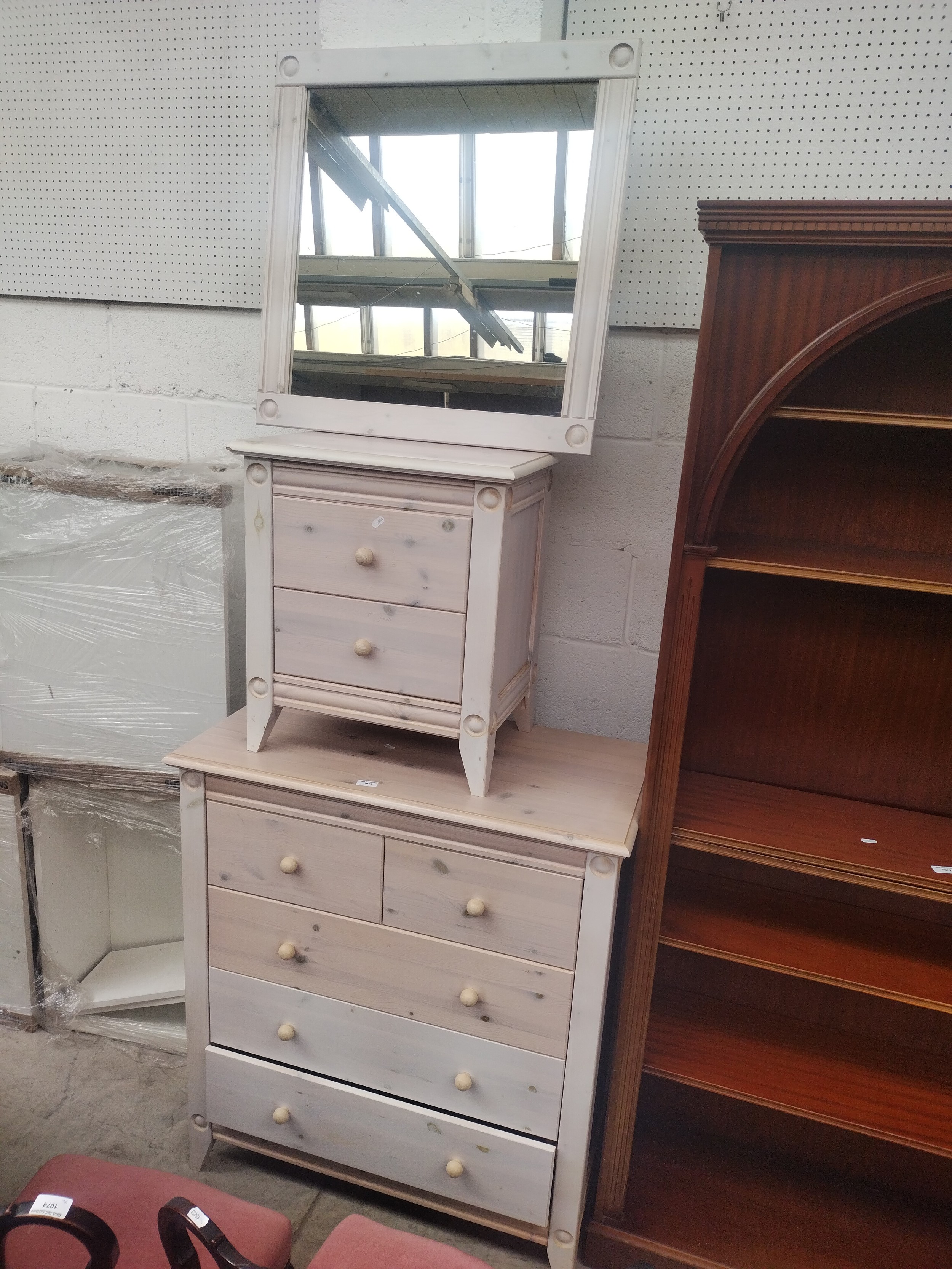 A limed finish 2 over 3 drawer chest with a matching 2 drawer chest and framed