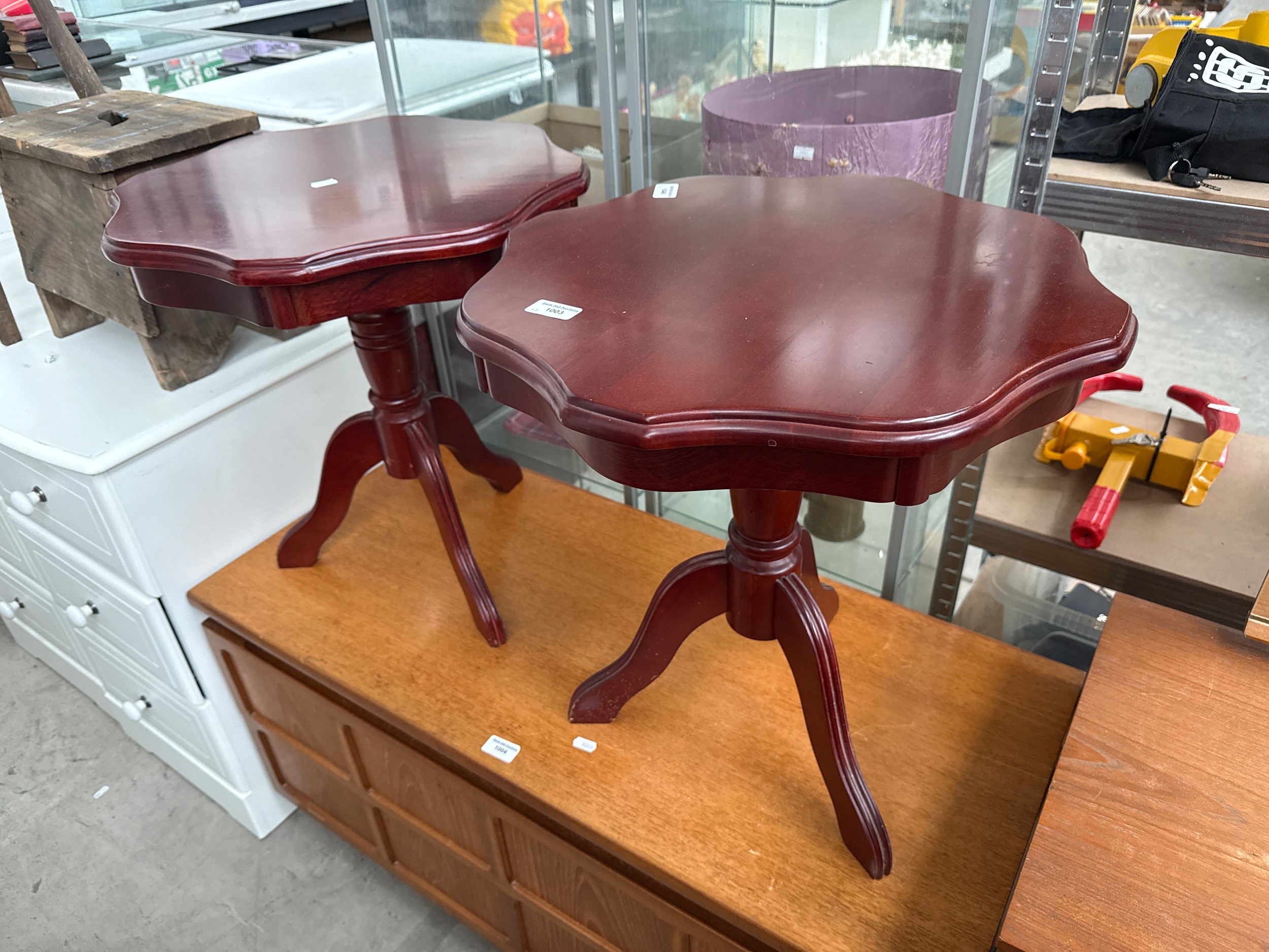 A pair of shaped mahogany tripod tables