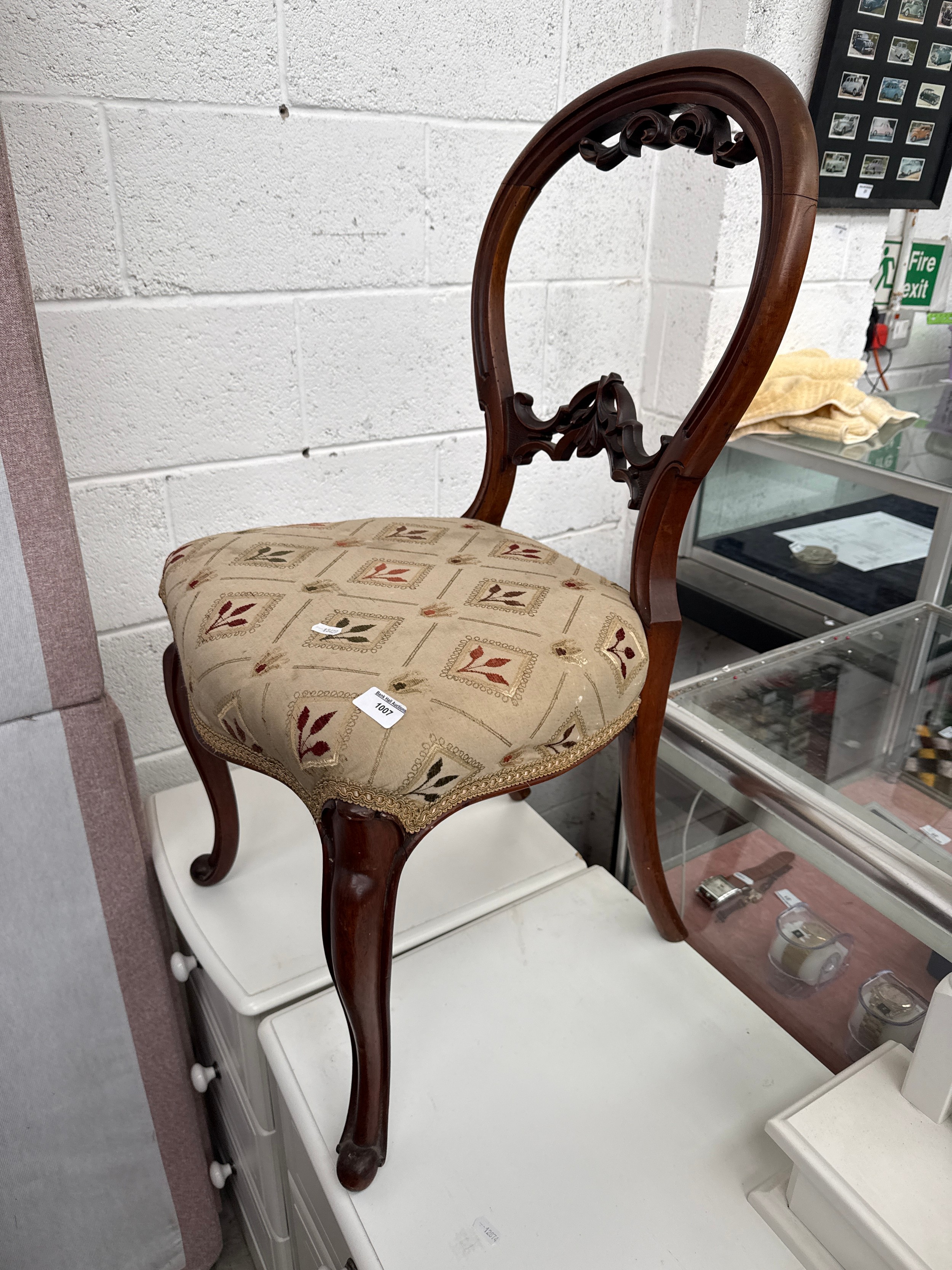 A vintage carved spoon back chair with upholstered seat