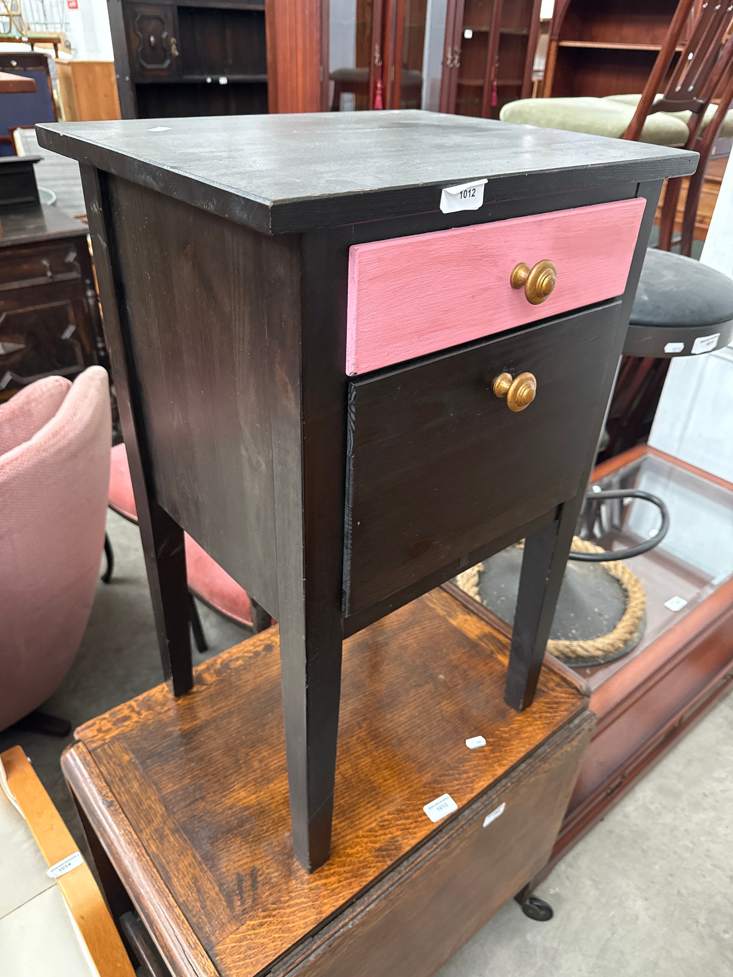 A painted bedside with drawer and fall front cupboard