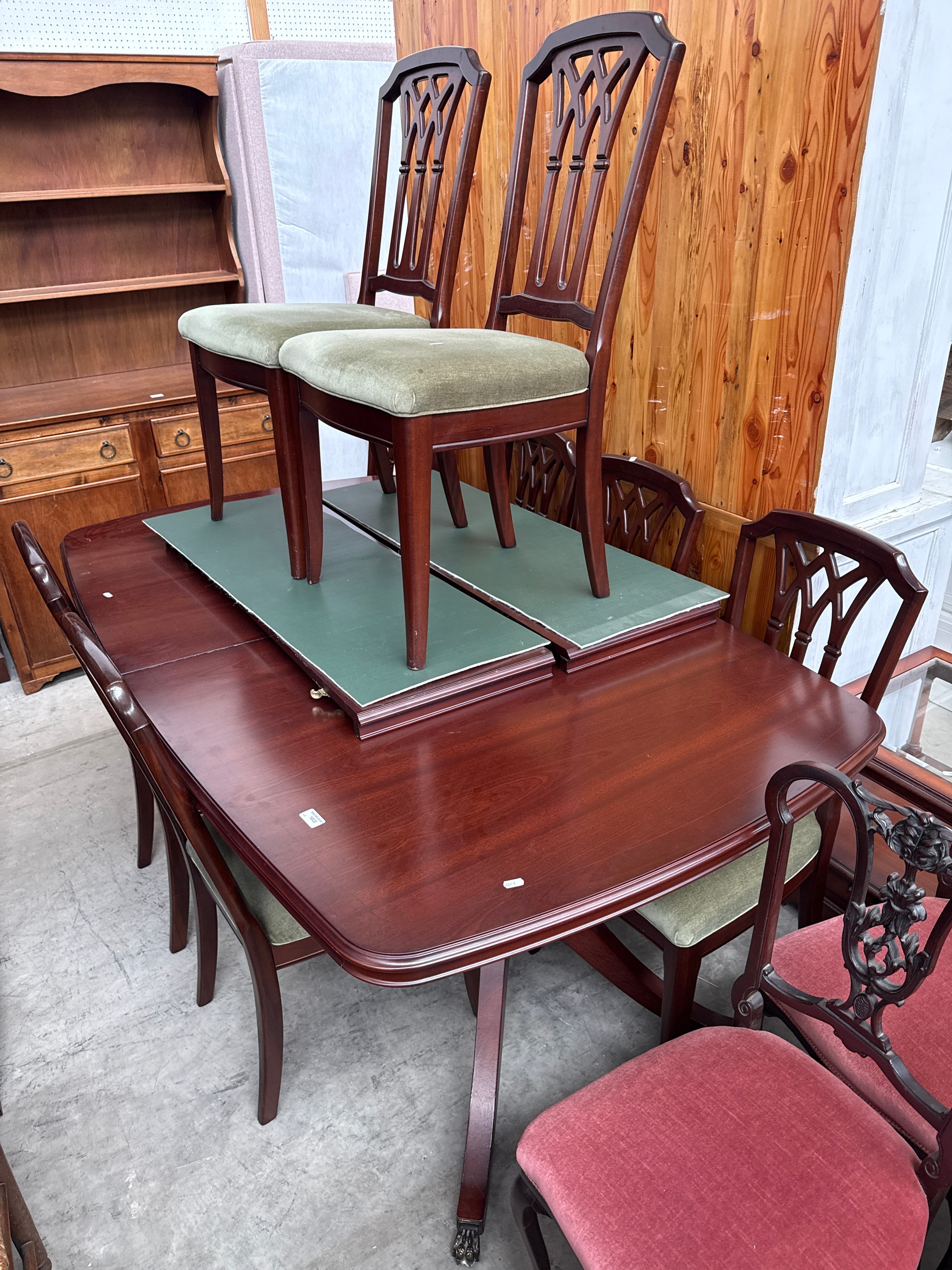 A large vintage extending mahogany splayed twin pedestal dining table with 8 x