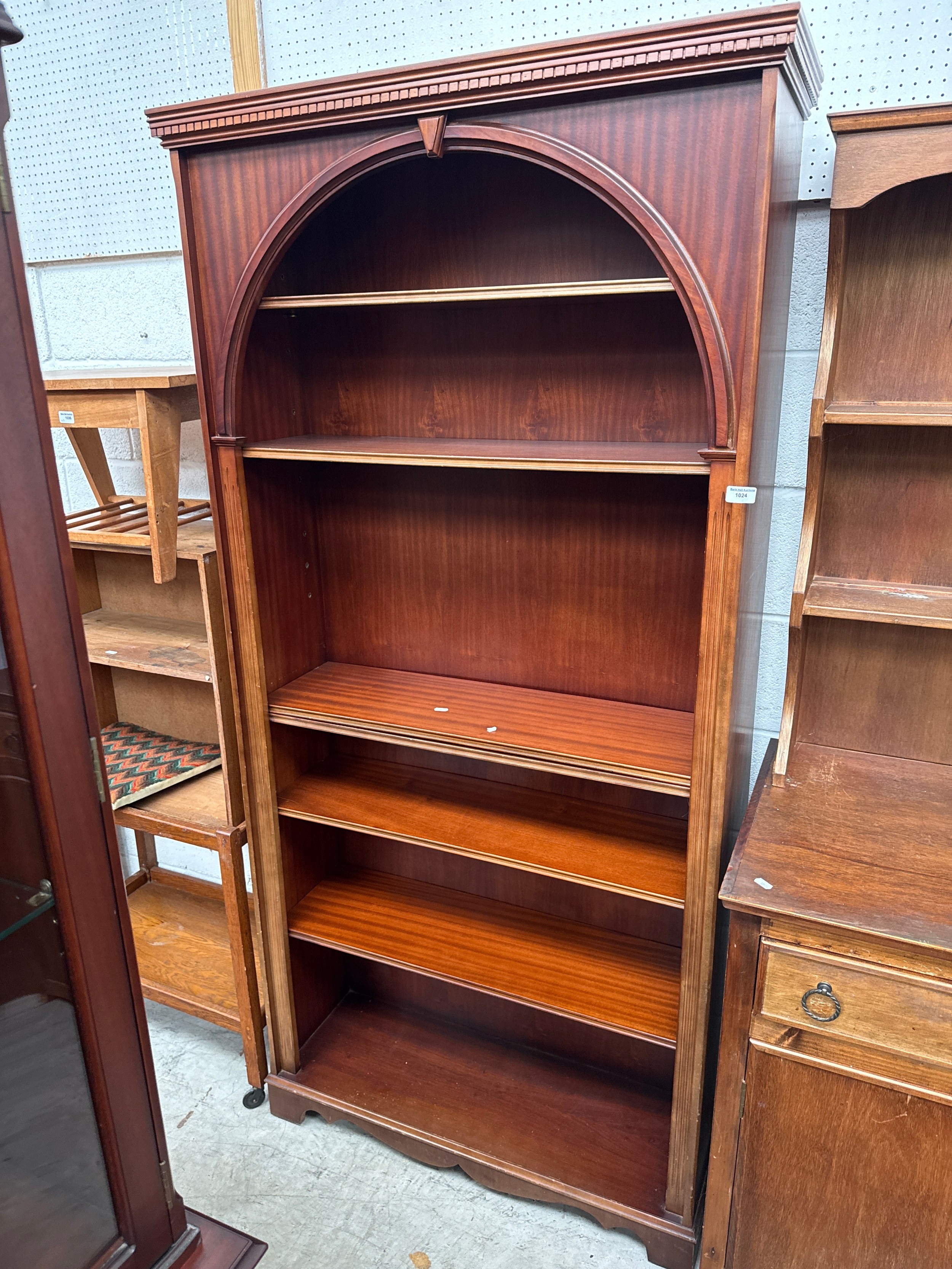 A vintage 7 tier mahogany open bookcase with top decoration and adjustable