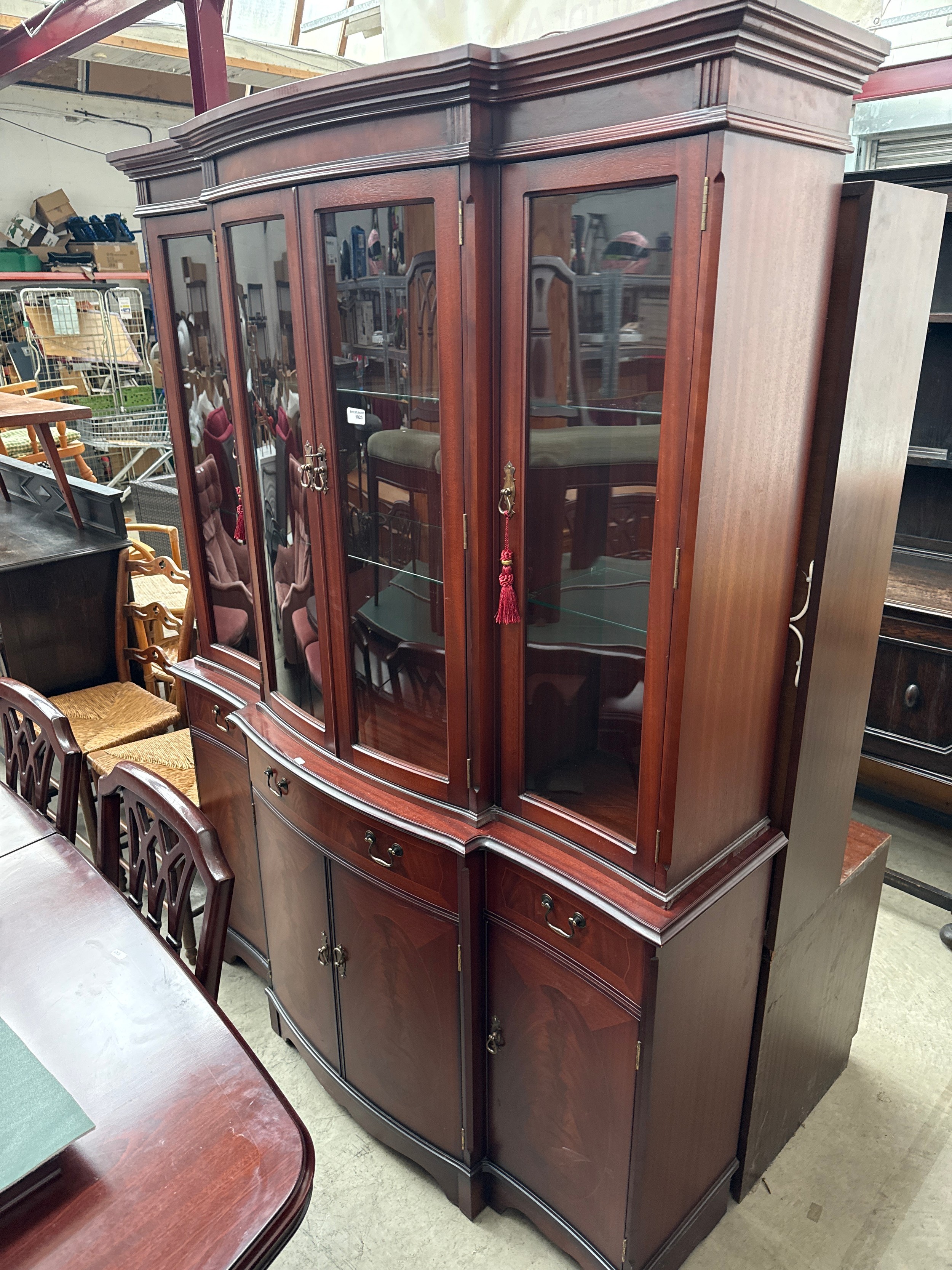 A large vintage mahogany cabinet with glazed 4 door top on 3 drawer 4 door base