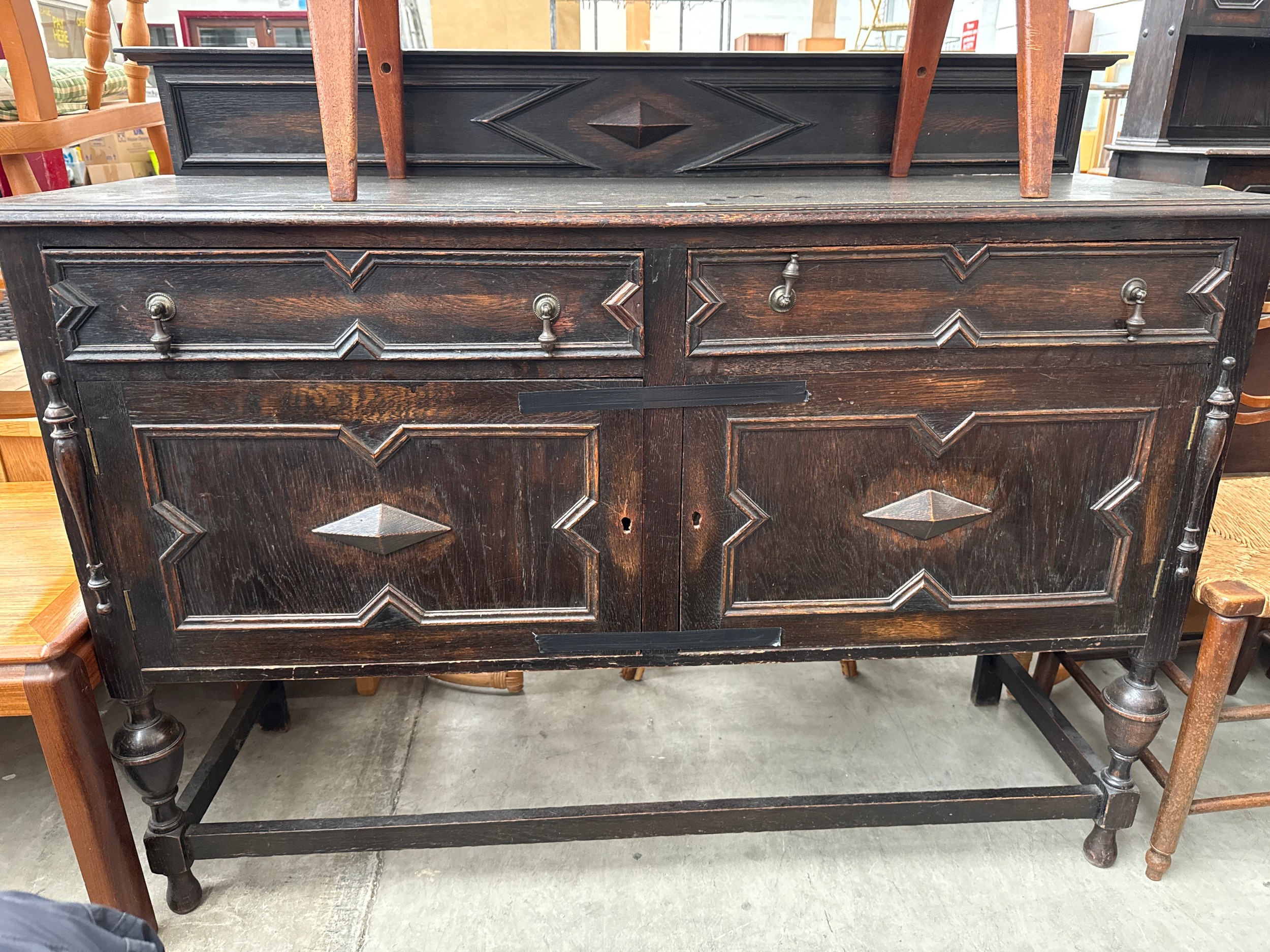 A large oak Jacobean style 2 drawer sideboard with upstand and bulbous legs