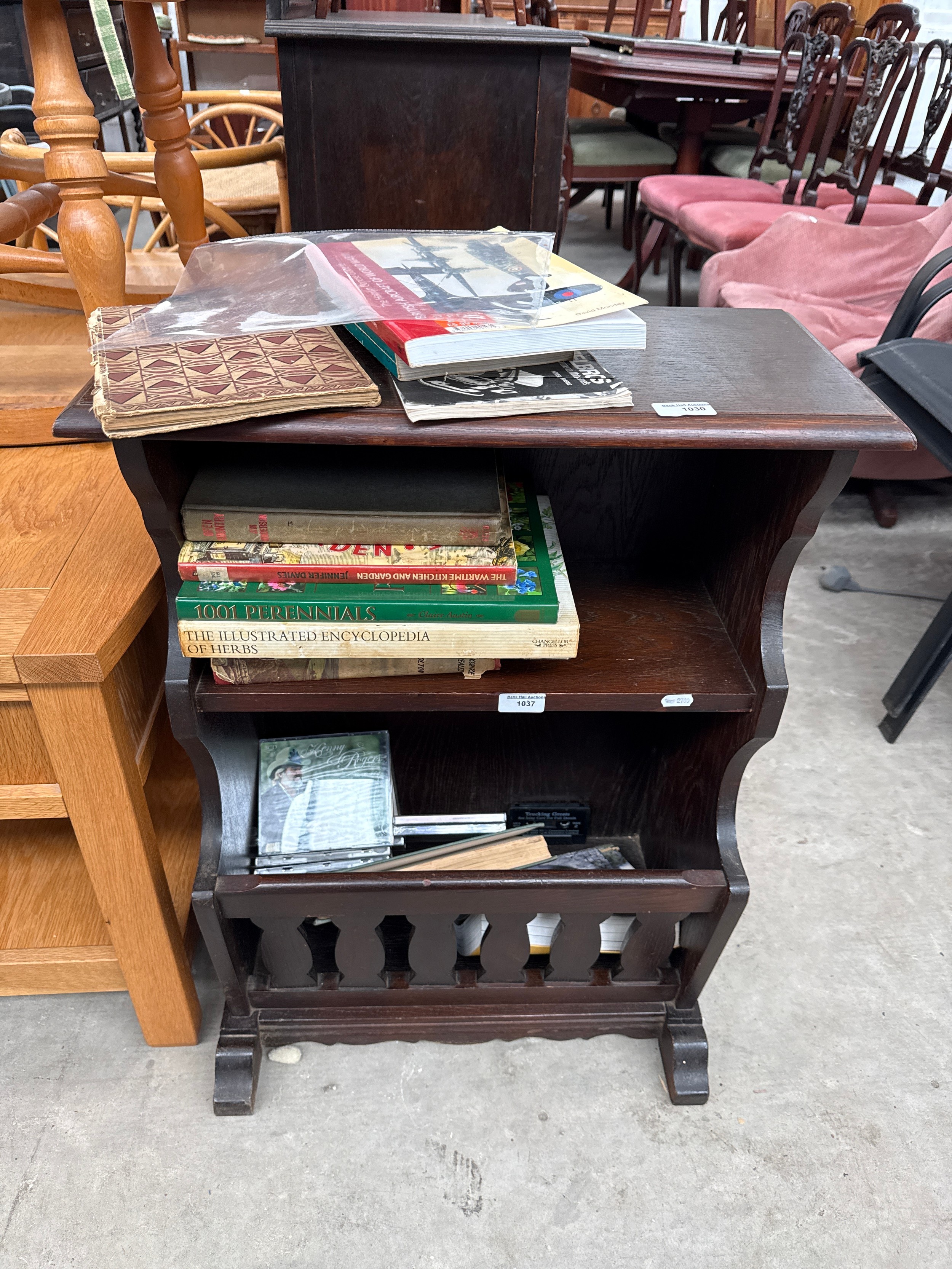 A vintage oak magazine rack stand with upper shelf