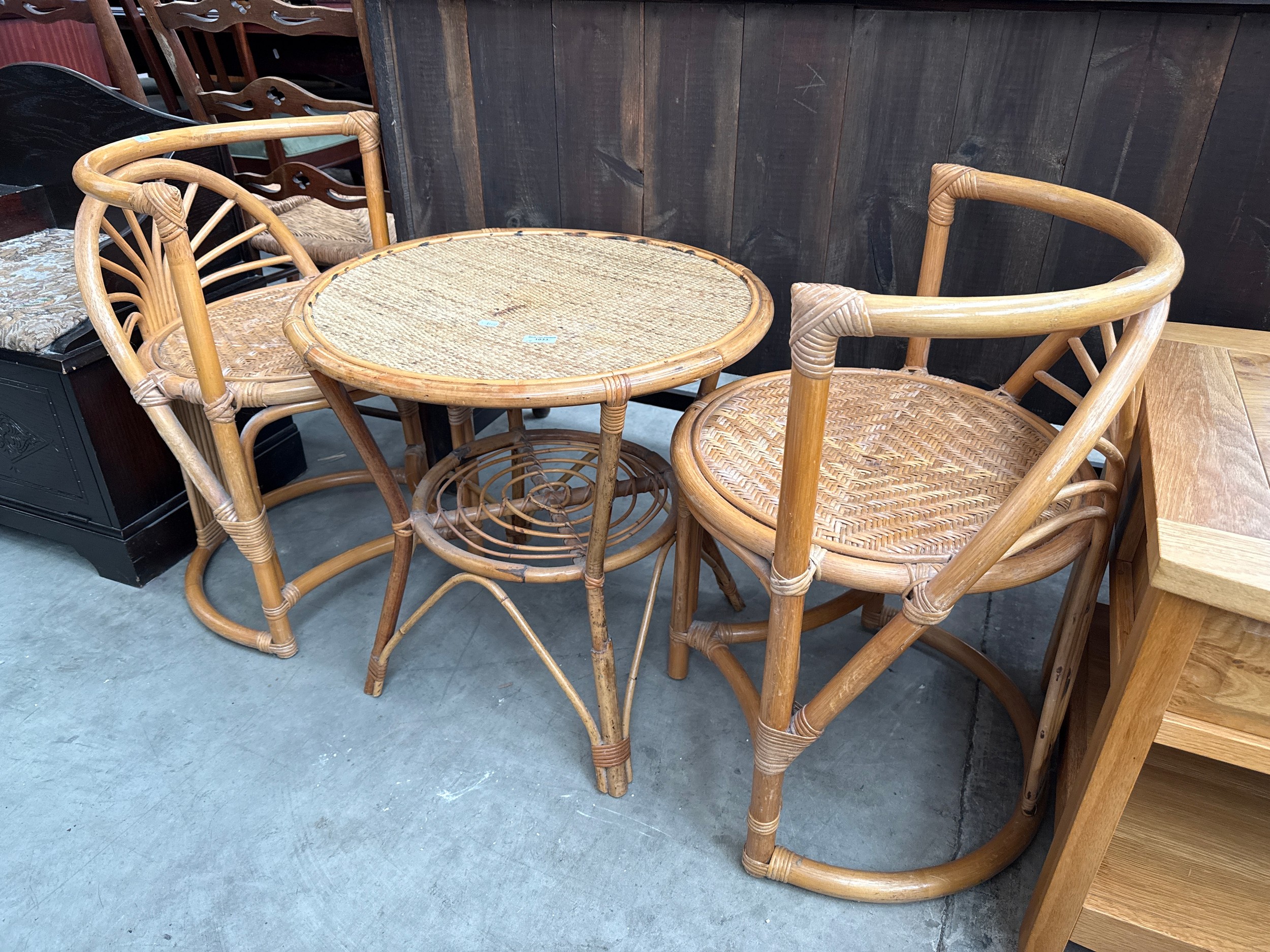 A 3 piece cane framed set with small table and 2 x chairs