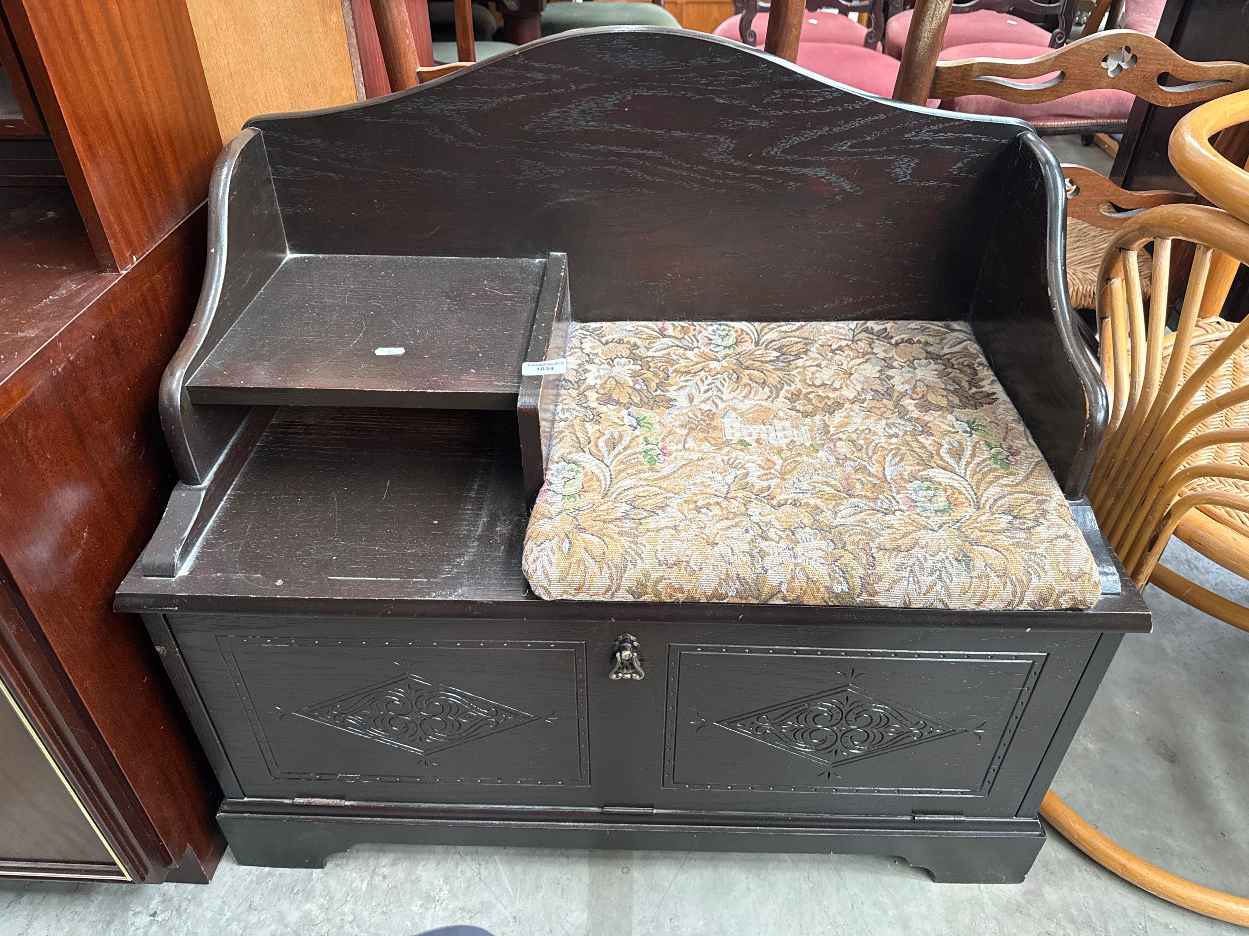 A vintage hall seat unit with fall front cupboard