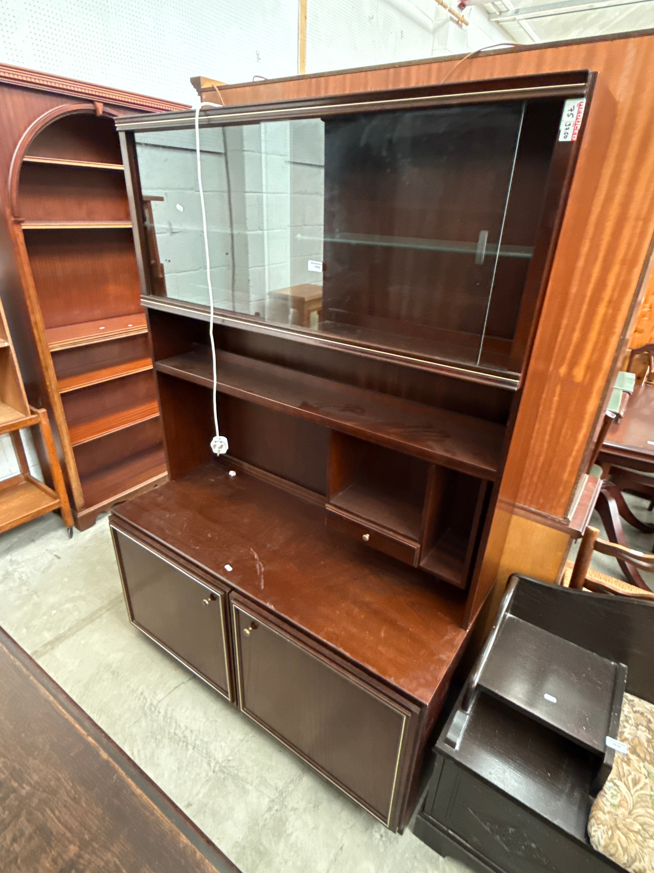 A retro mahogany wall unit with glazed upper doors