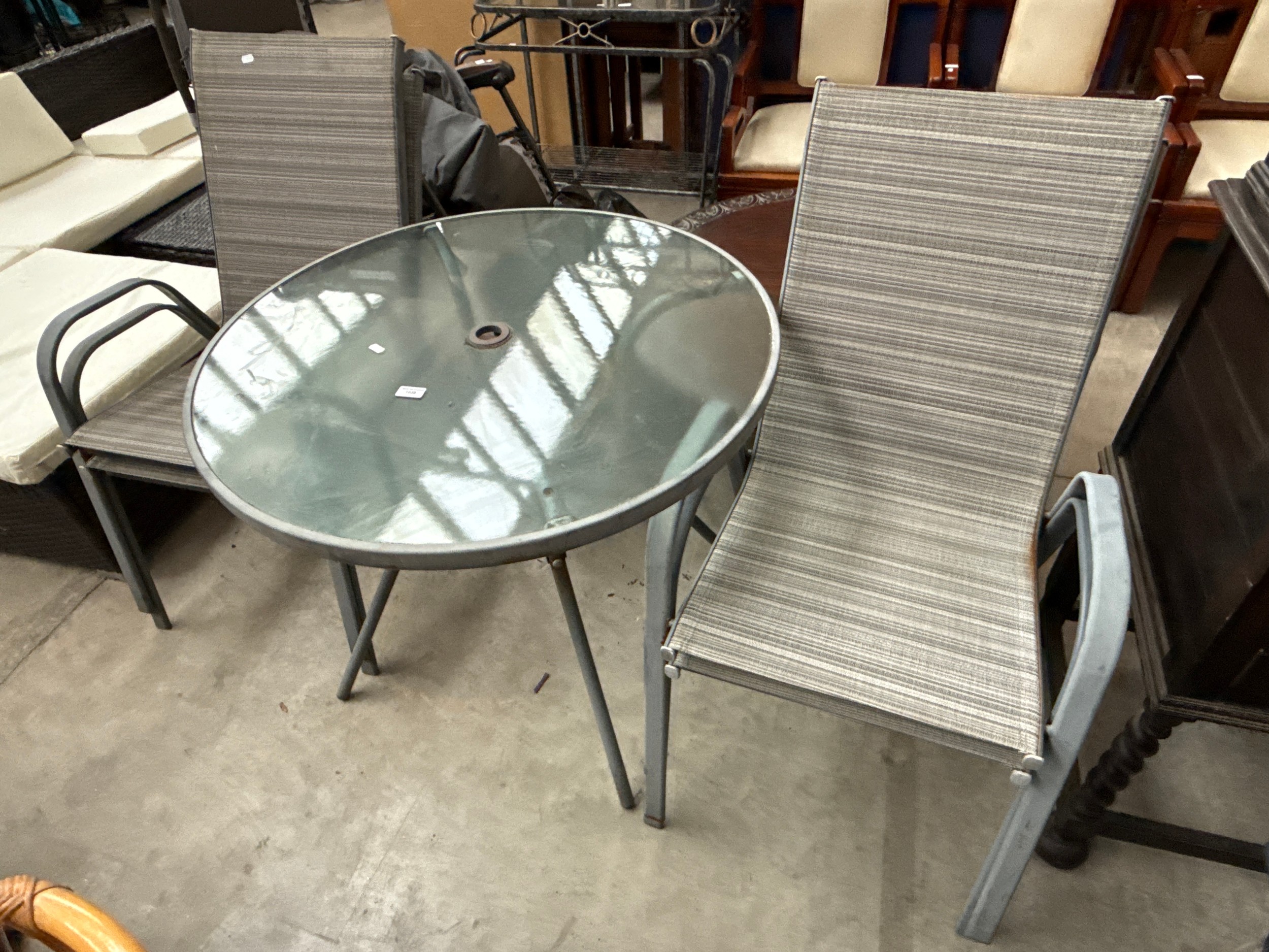 A 5 piece metal framed patio set with glass top table and 4 x chairs
