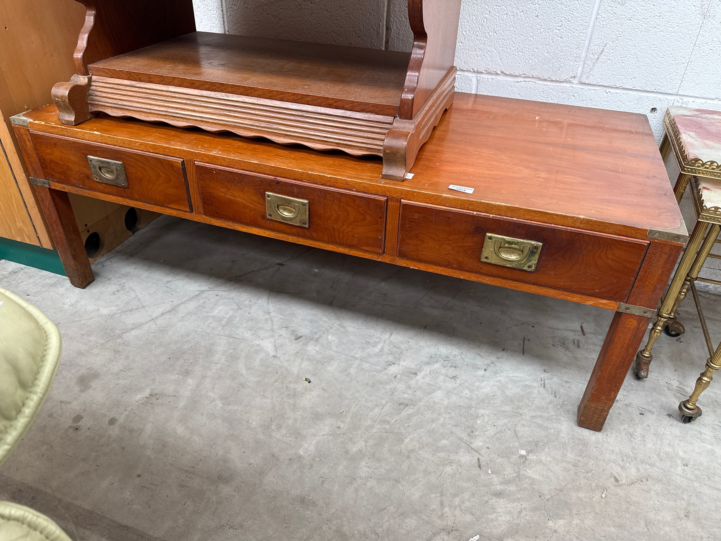A large vintage coffee table with brass fittings and 3 lower drawers