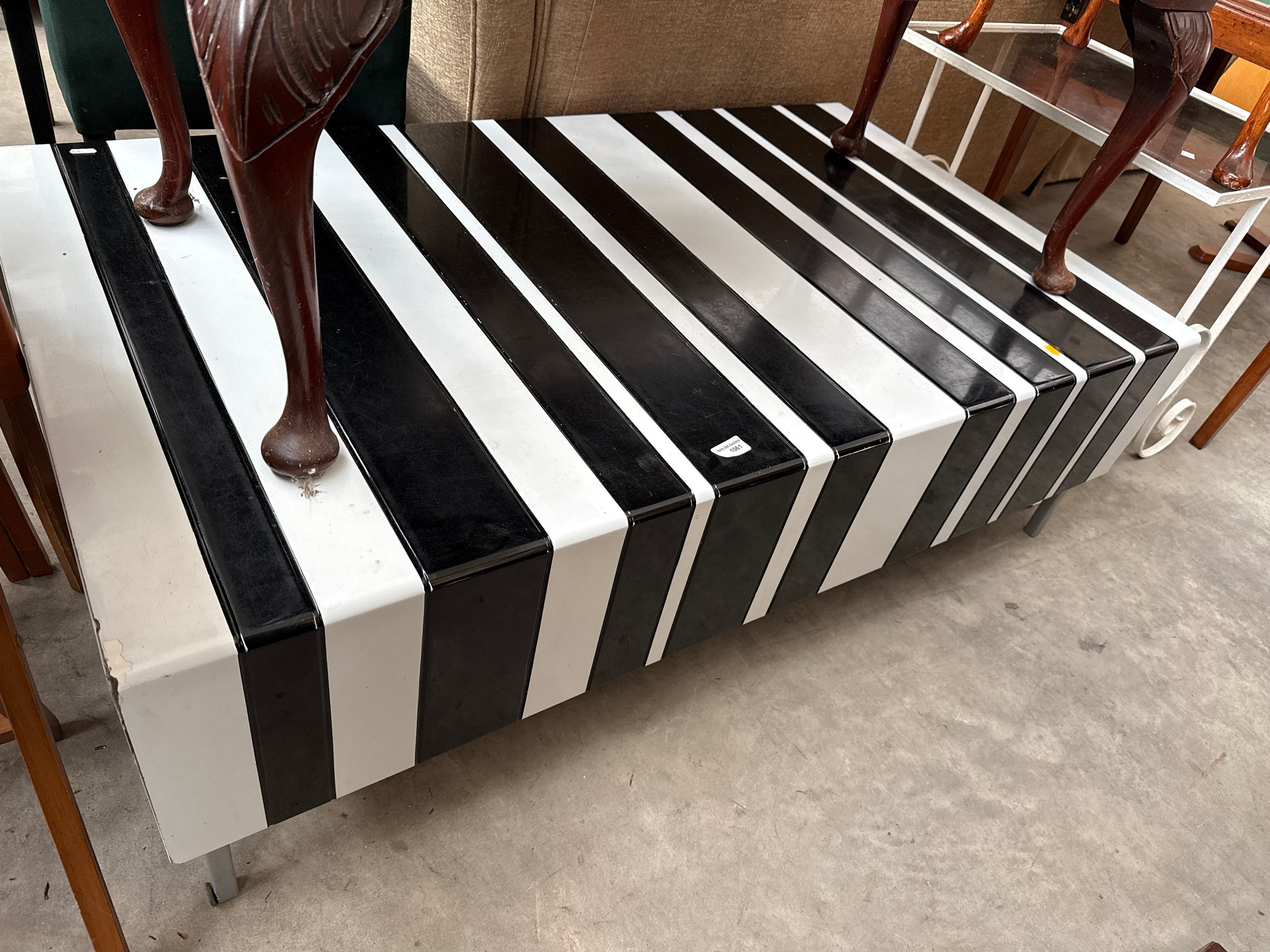 A large black and white gloss coffee table unit with end drawers