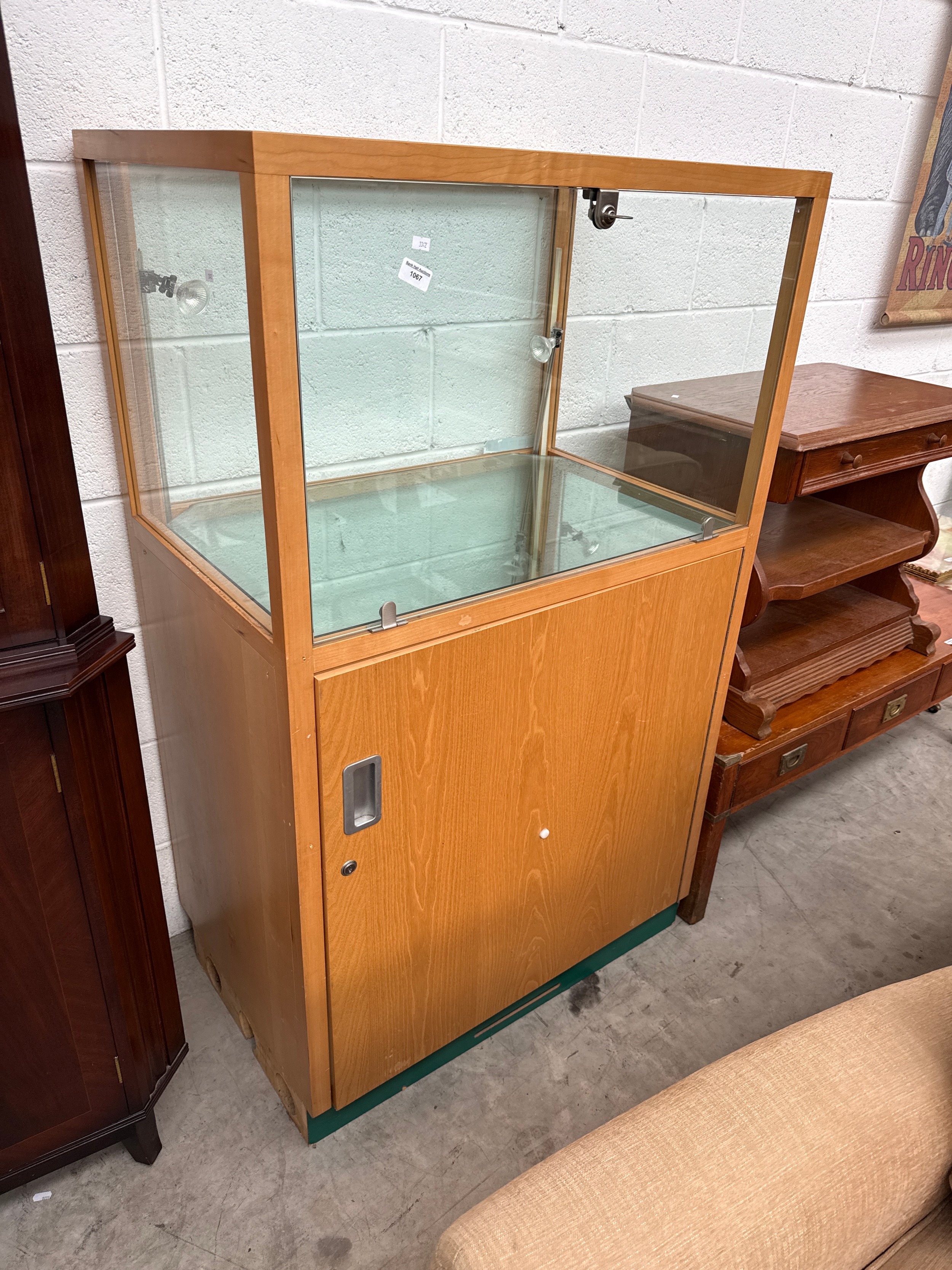 A large glazed retail style lockable display/storage cabinet