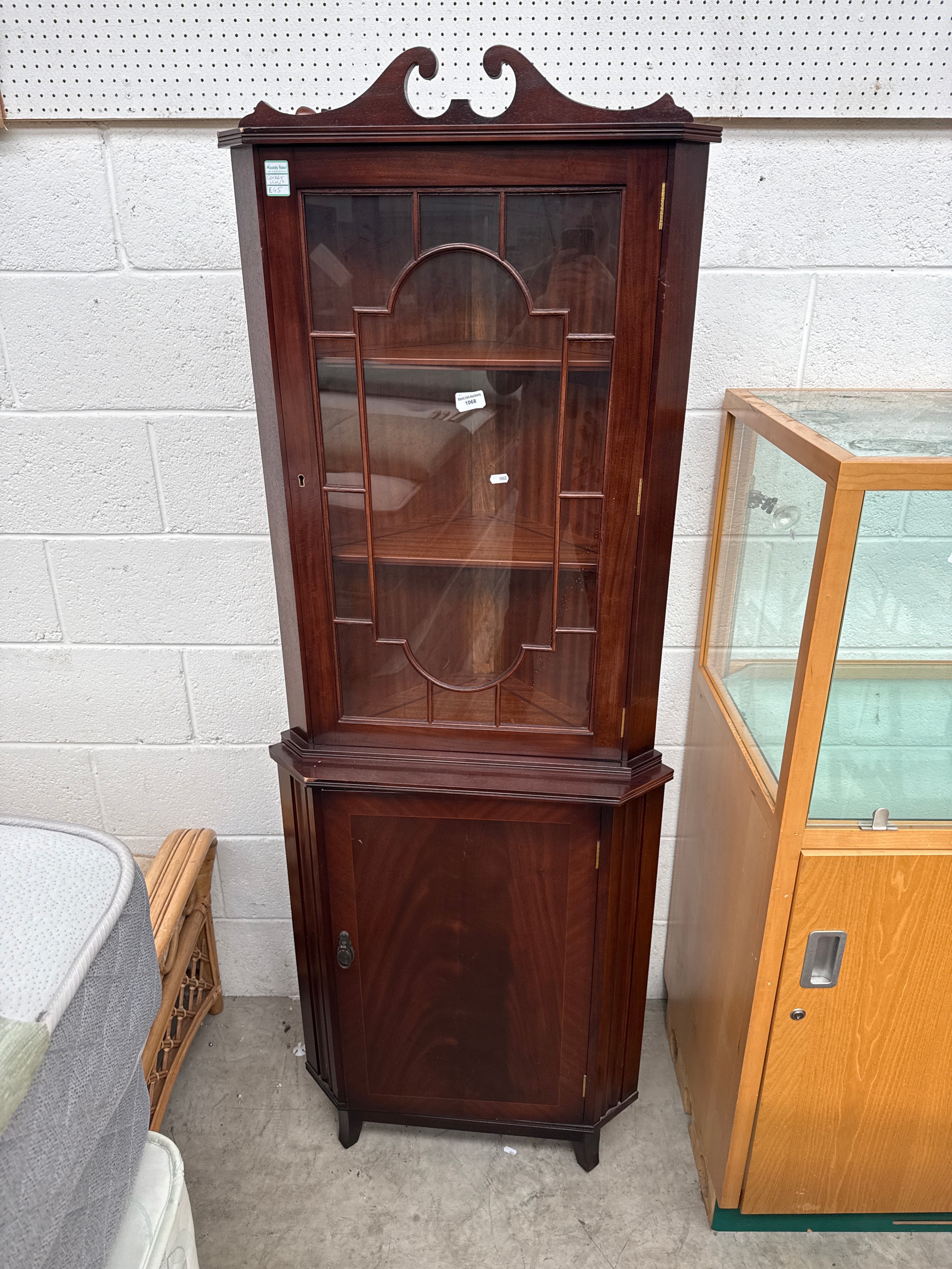 A vintage glazed mahogany corner cabinet