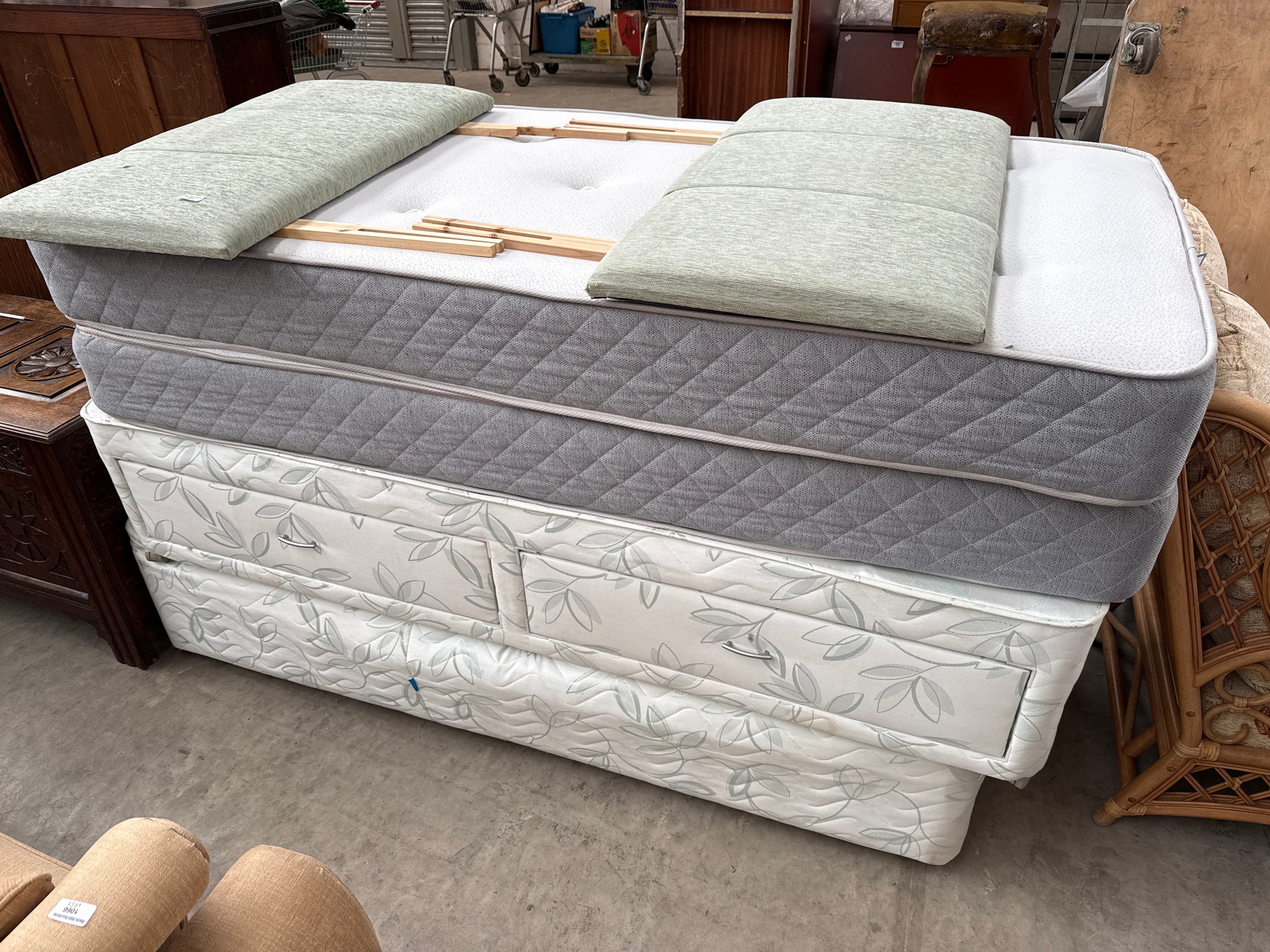 A pair of single beds with mattresses and headboards