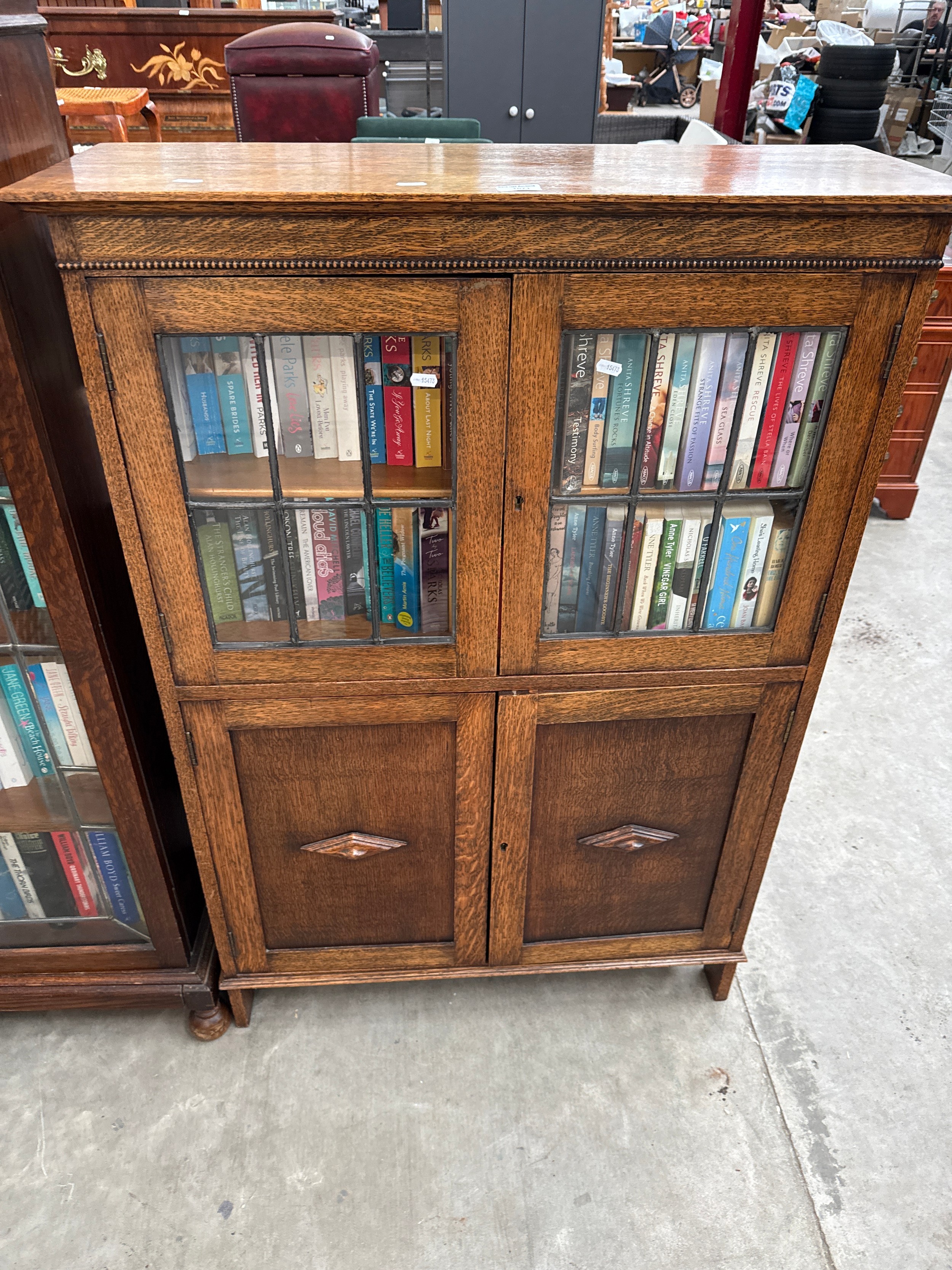 A vintage glazed oak 4 door bookcase with contents
